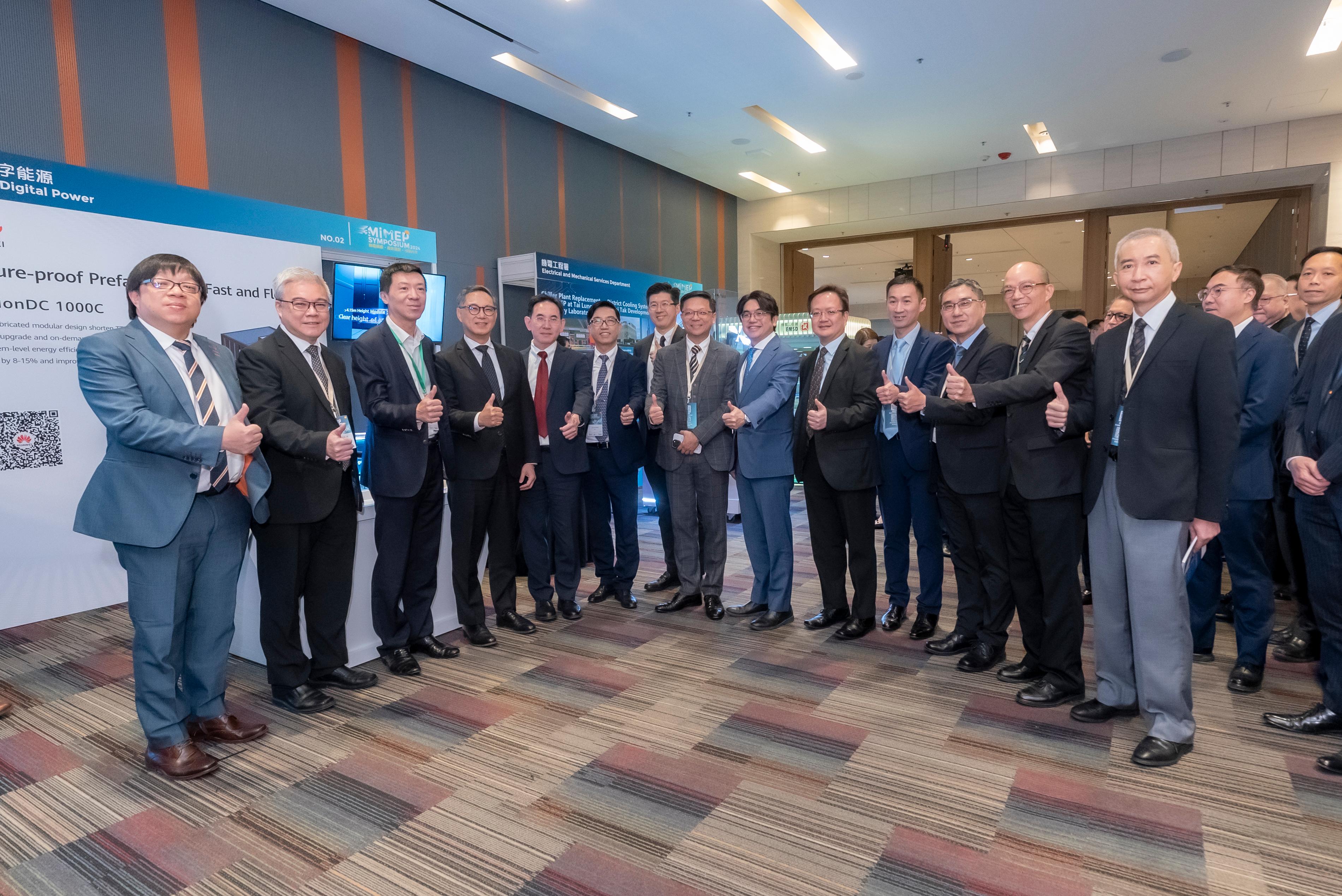 The MiMEP Symposium 2024, co-organised by the Architectural Services Department and the Electrical and Mechanical Services Department, was held at the Hong Kong Science Park today (November 29). Photo shows the Under Secretary for Development, Mr David Lam (fifth left); the Permanent Secretary for Development (Works), Mr Ricky Lau (fourth left); the Director of Architectural Services, Mr Michael Li (seventh left); the Director of Electrical and Mechanical Services, Mr Raymond Poon (second left), and other guests and participants at the symposium.