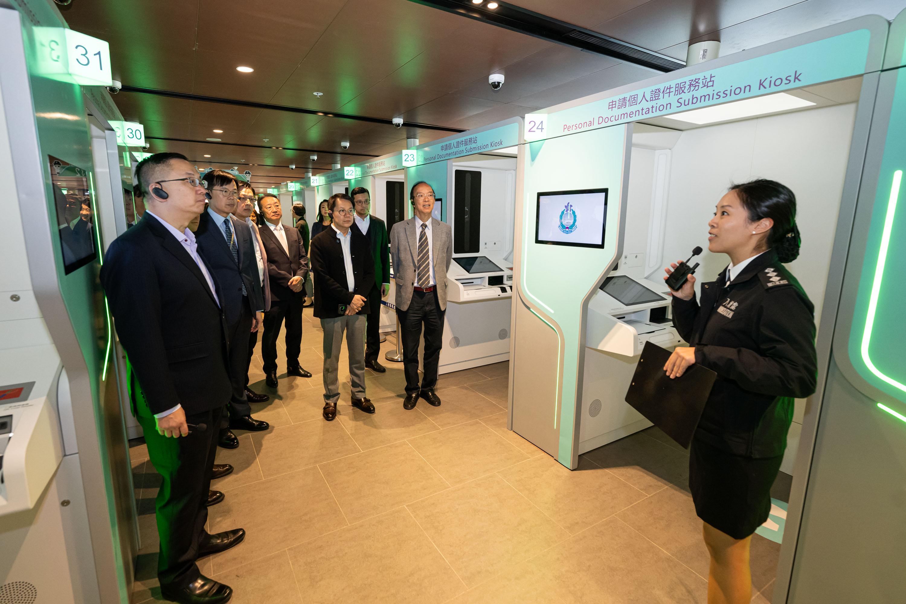 The Legislative Council Panel on Security visited the headquarters of the Immigration Department (ImmD) today (December 2). Photo shows Members observing the operation of self-service personal documentation services at Registration of Persons - Tseung Kwan O Office.
