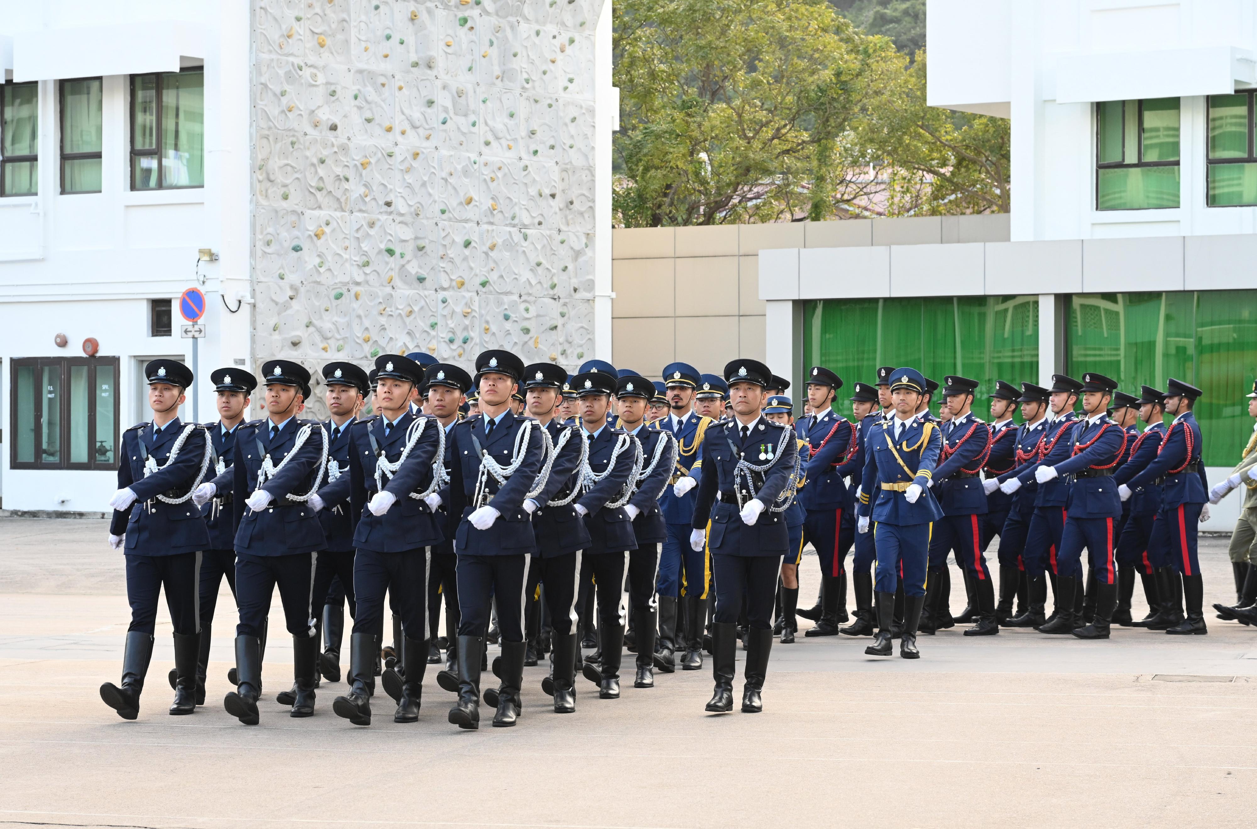 The Security Bureau today (December 4) held the Constitution Day Flag Raising Ceremony. Photo shows the disciplined services ceremonial guard marching into the venue with Chinese-style foot drill and conducting the flag-raising ceremony.