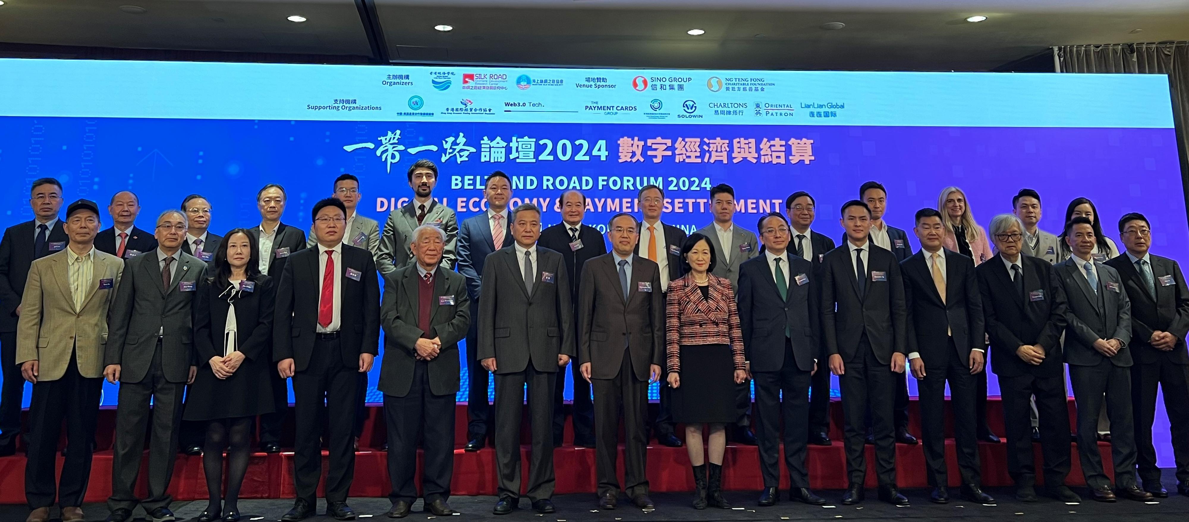 The Secretary for Financial Services and the Treasury, Mr Christopher Hui (front row, seventh left), attended the Belt and Road Forum 2024 - Digital Economy & Payment Settlement today (December 5). Photo shows Mr Hui (front row, seventh left) with other guests.

