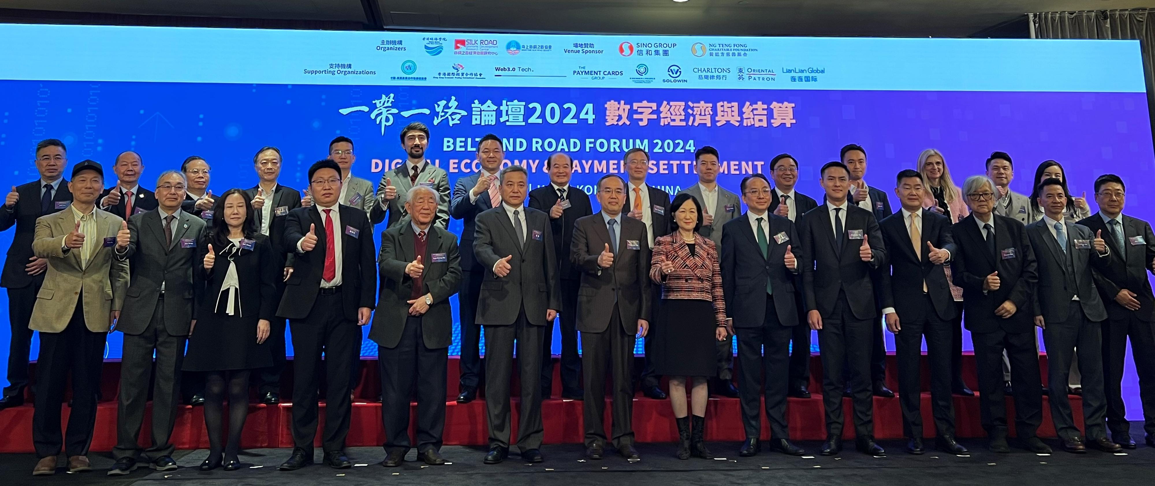 The Secretary for Financial Services and the Treasury, Mr Christopher Hui (front row, seventh left), attended the Belt and Road Forum 2024 - Digital Economy & Payment Settlement today (December 5). Photo shows Mr Hui (front row, seventh left) with other guests.

