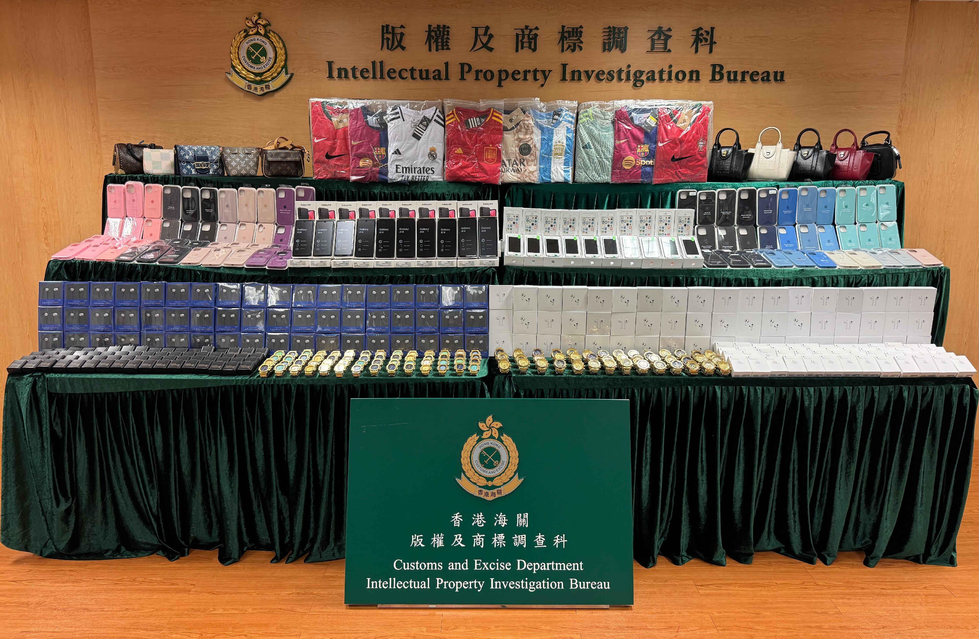 Hong Kong Customs conducted a two-week joint operation with the Mainland and Macao Customs from November 18 to 30 to combat cross-boundary and transshipment counterfeiting activities. During the operation, Hong Kong Customs detected 26 cases and seized about 36 000 items of suspected counterfeit goods, including mobile phone accessories, watches, jerseys and handbags, with a total estimated market value of about $11 million. Photo shows some of the suspected counterfeit goods seized.
