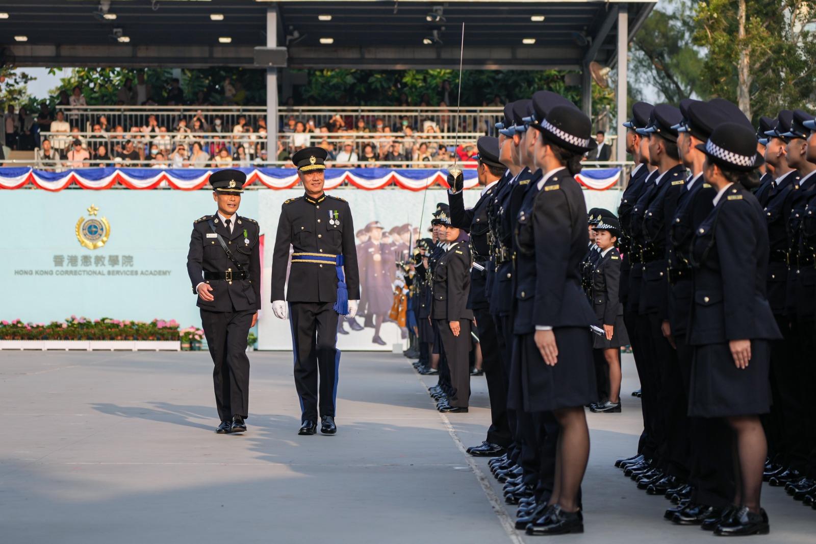 The Correctional Services Department held a passing-out parade at the Hong Kong Correctional Services Academy today (December 6). Photo shows the Deputy Commissioner of Correctional Services (Rehabilitation and Management), Dr Leung Kin-ip (second left), inspecting a contingent of graduates.