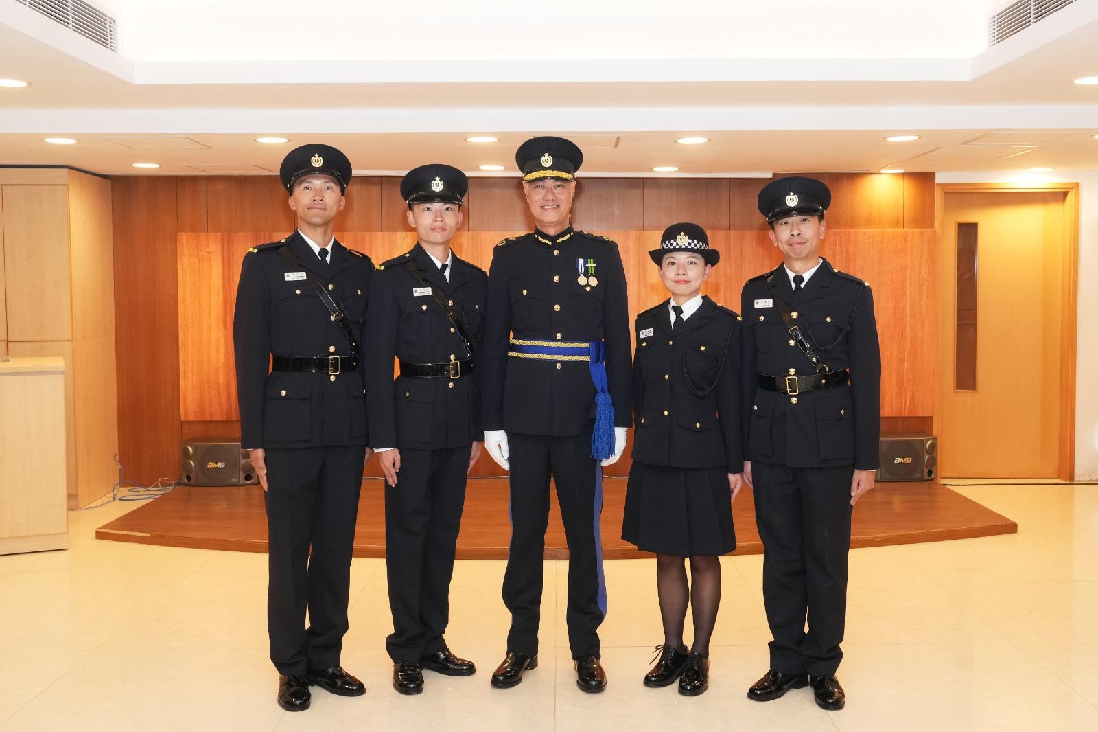 The Deputy Commissioner of Correctional Services (Rehabilitation and Management), Dr Leung Kin-ip, reviewed the Correctional Services Department passing-out parade today (December 6). Photo shows Dr Leung (centre) with the awardees of the Best Recruit Award, the Golden Whistle.