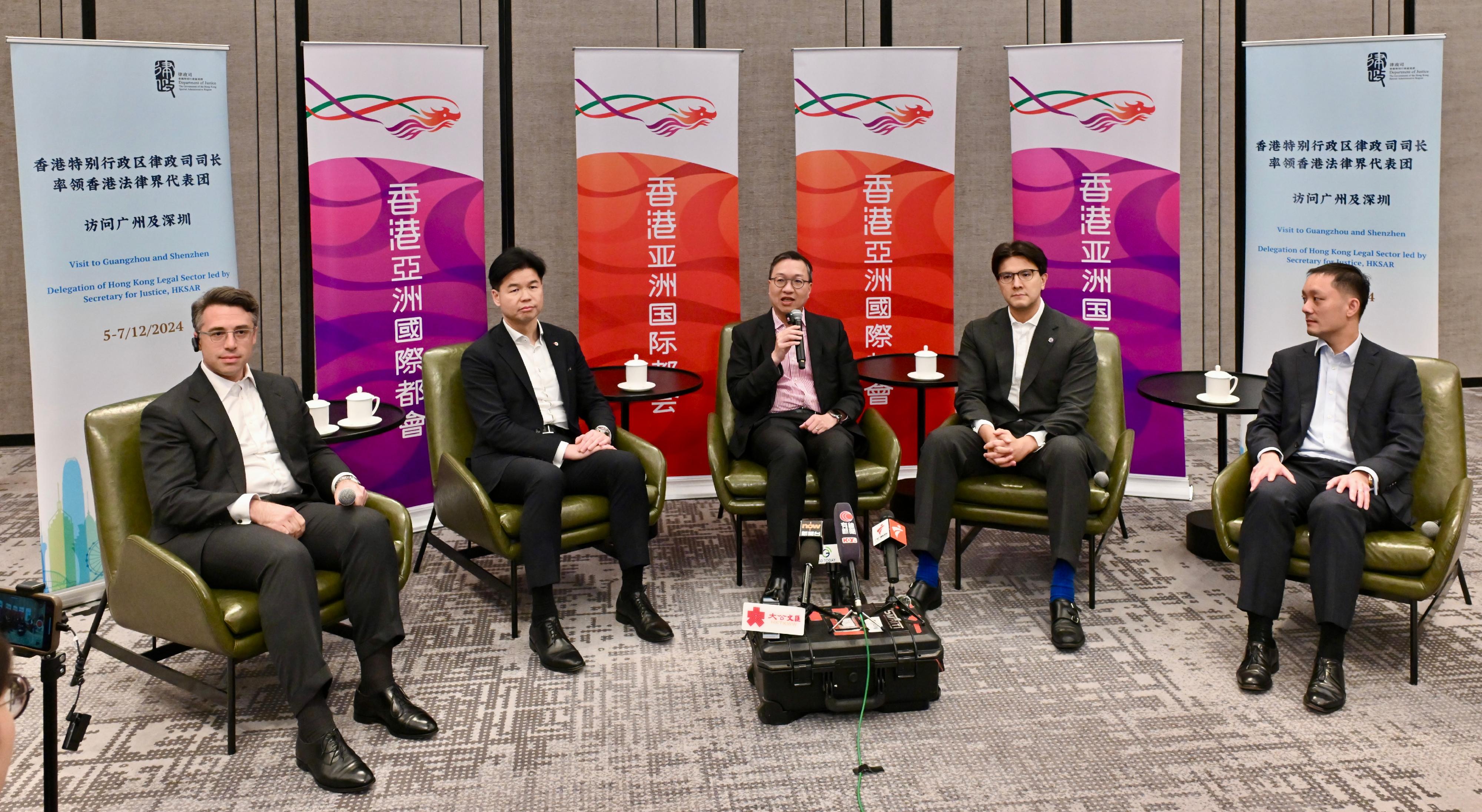 The Secretary for Justice, Mr Paul Lam, SC, leading a Hong Kong delegation of over 30 representatives of foreign-related legal talent from Hong Kong, departed for Shenzhen today (December 6) to continue his visit to Mainland cities of the Guangdong-Hong Kong-Macao Greater Bay Area. Photo shows Mr Lam (centre); the President of the Law Society of Hong Kong, Mr Roden Tong (second left); Vice-Chairman of the Hong Kong Bar Association Mr José-Antonio Maurellet, SC (second right); and representatives of the delegation Mr Benjamin Edward Maurice Hammond (first left) and Mr Ng Jern-fei, KC (first right), in an interview with media organisations based in the Mainland.