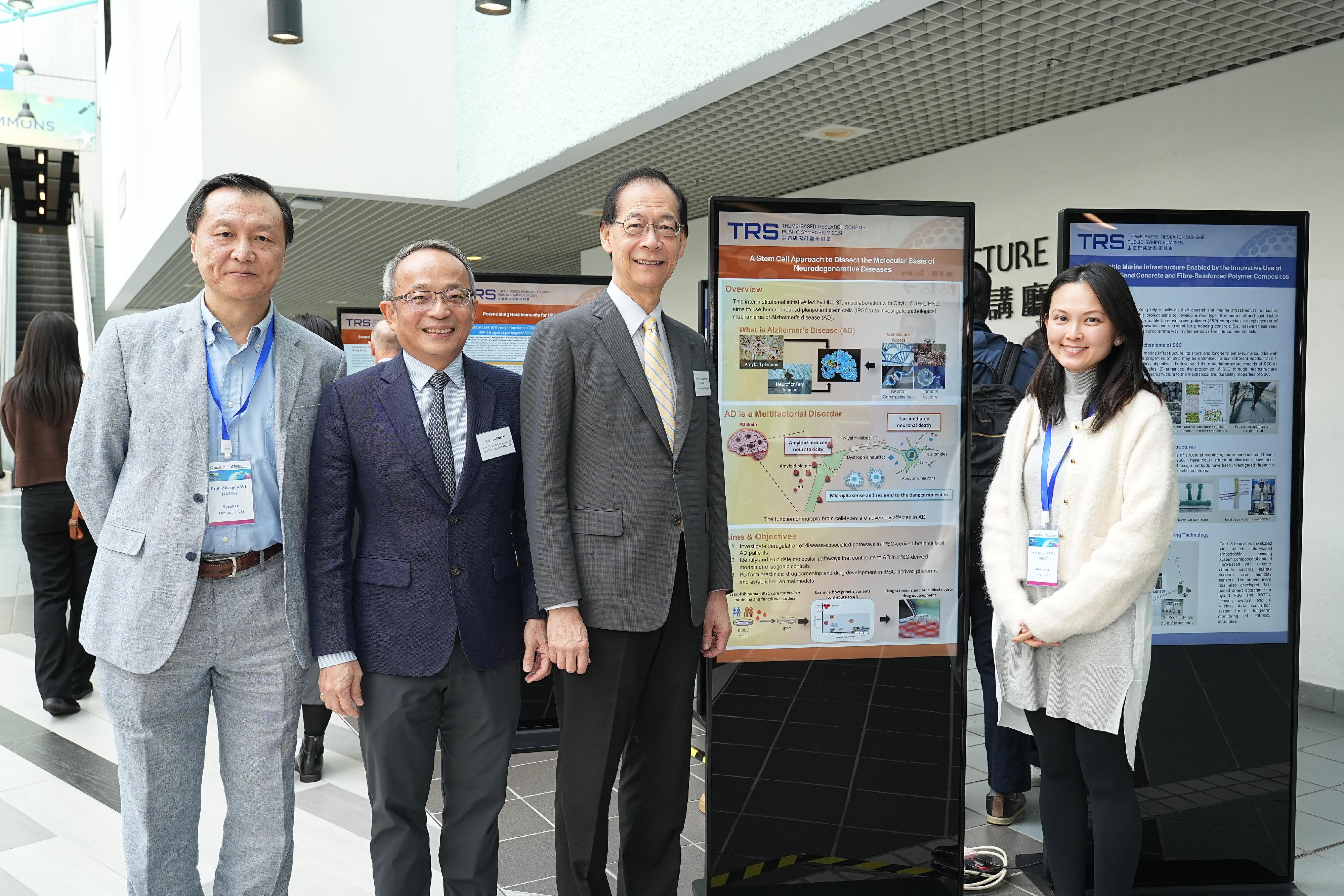 The Research Grants Council (RGC) held the Theme-based Research Scheme Public Symposium 2024 at the Hong Kong University of Science and Technology (HKUST) today (December 8). Photo shows the Chairman of the RGC, Professor Timothy W. Tong (second right), the Vice-President for Research and Development of the HKUST, Professor Tim Cheng (second left), and the project team of the Theme-based Research Scheme project "A Stem Cell Approach to Dissect the Molecular Basis of Neurodegenerative Diseases".