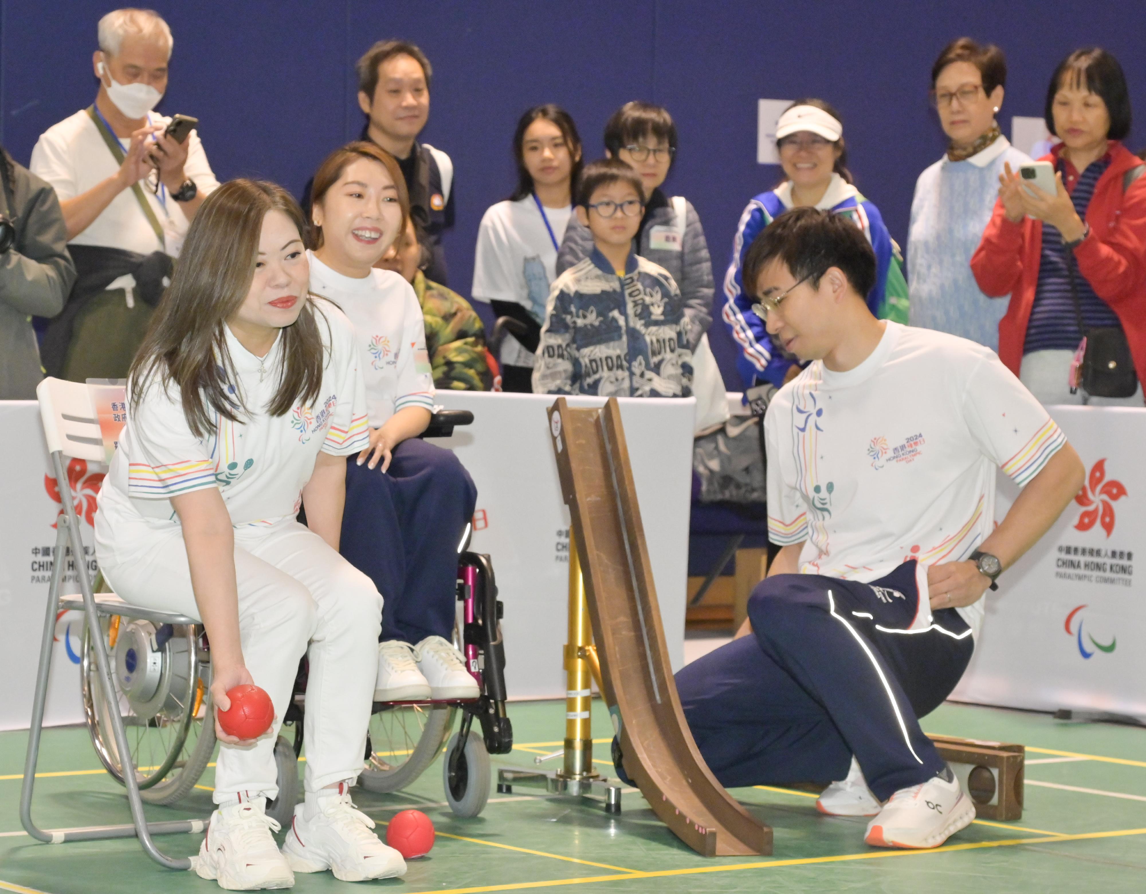 Hong Kong Paralympic Day 2024 and one-year countdown campaign of the 12th National Games for Persons with Disabilities and the 9th National Special Olympic Games (Hong Kong) was held at the Hong Kong Sports Institute today (December 8). Photo shows the Secretary for Culture, Sports and Tourism, Miss Rosanna Law (front row, first left), accompanied by the Hong Kong boccia athlete Ho Yuen-kei (front row, second left), experiencing boccia.