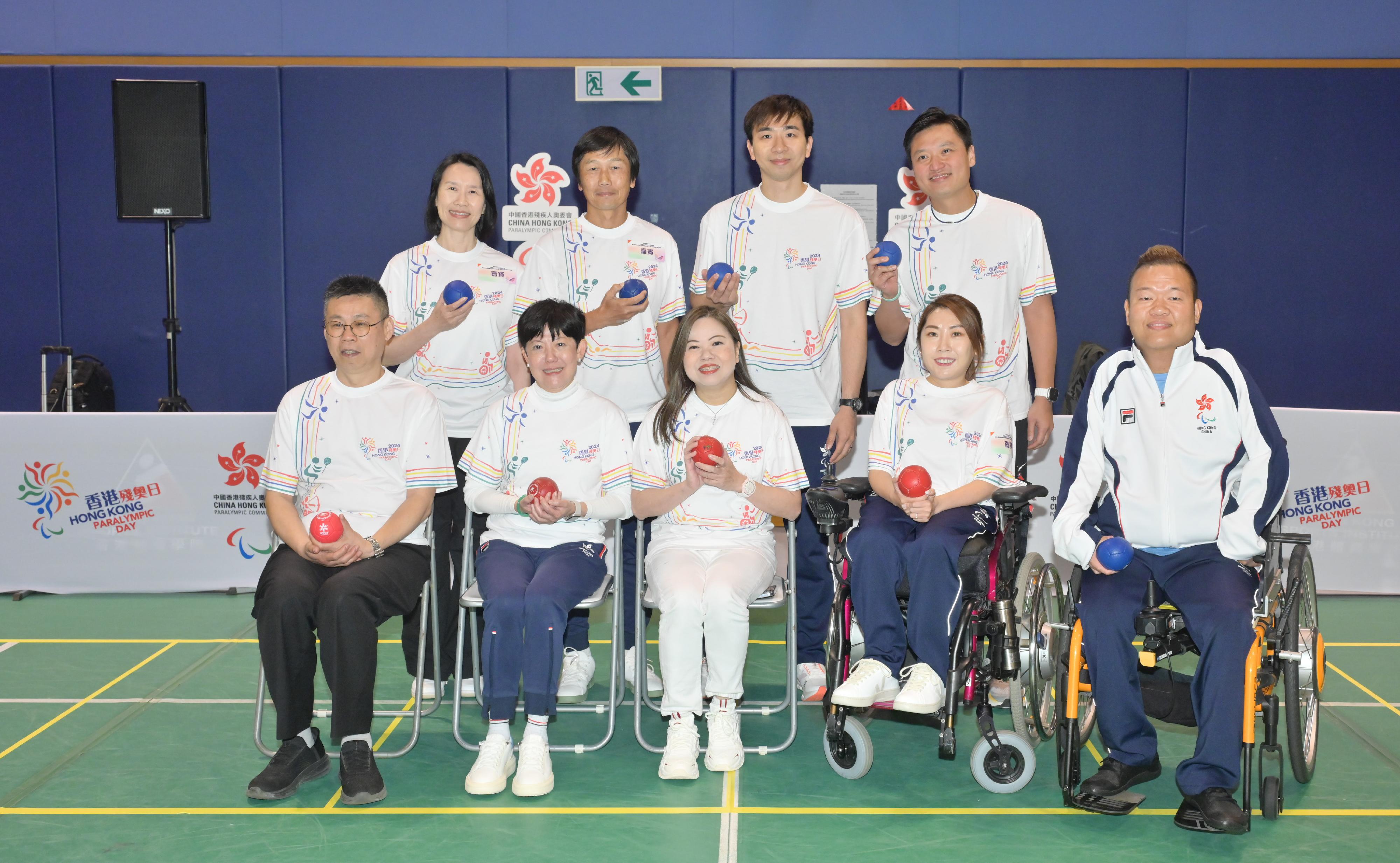 Hong Kong Paralympic Day 2024 and one-year countdown campaign of the 12th National Games for Persons with Disabilities and the 9th National Special Olympic Games (Hong Kong) was held at the Hong Kong Sports Institute today (December 8). Photo shows the Secretary for Culture, Sports and Tourism, Miss Rosanna Law (front row, centre), the Head of the National Games Coordination Office (Hong Kong), Mr Yeung Tak-keung (back row, second left); the Director of Leisure and Cultural Services, Ms Manda Chan (back row, first left); Deputy Director-General of the Department of Publicity, Cultural and Sports Affairs of the Liaison Office of the Central People's Government in the Hong Kong Special Administrative Region Mr Sun Zhaomin (front row, first left); the President of the China Hong Kong Paralympic Committee, Mrs Jenny Fung (front row, second left), accompanied by the Hong Kong boccia athletes Ho Yuen-kei (front row, second right) and Leung Yuk-wing (front row, first right) experiencing boccia.