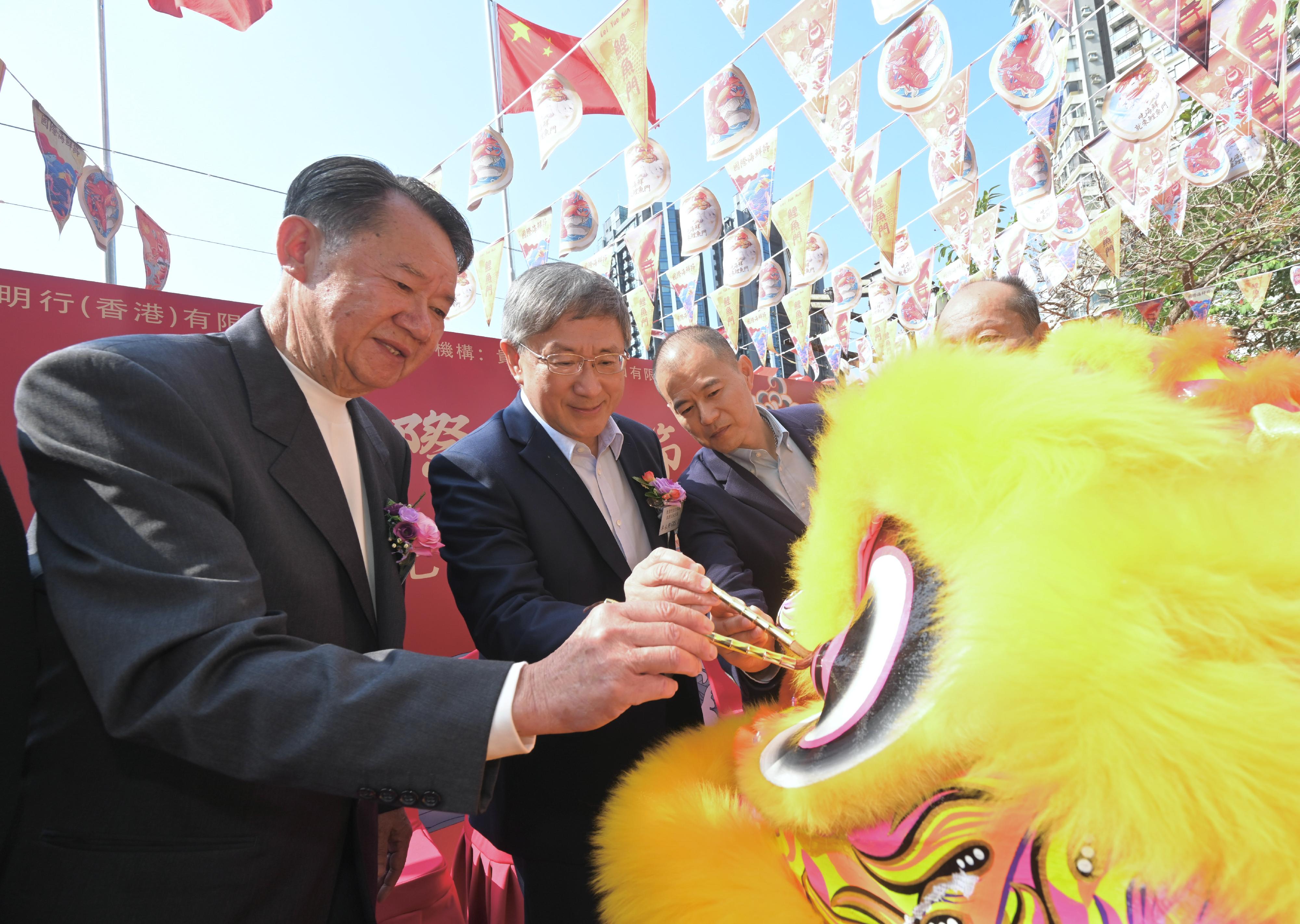 政务司副司长卓永兴（中）今日（十二月八日）出席鲤鱼门茅台国际海鲜节开幕典礼，并为彩狮点睛。