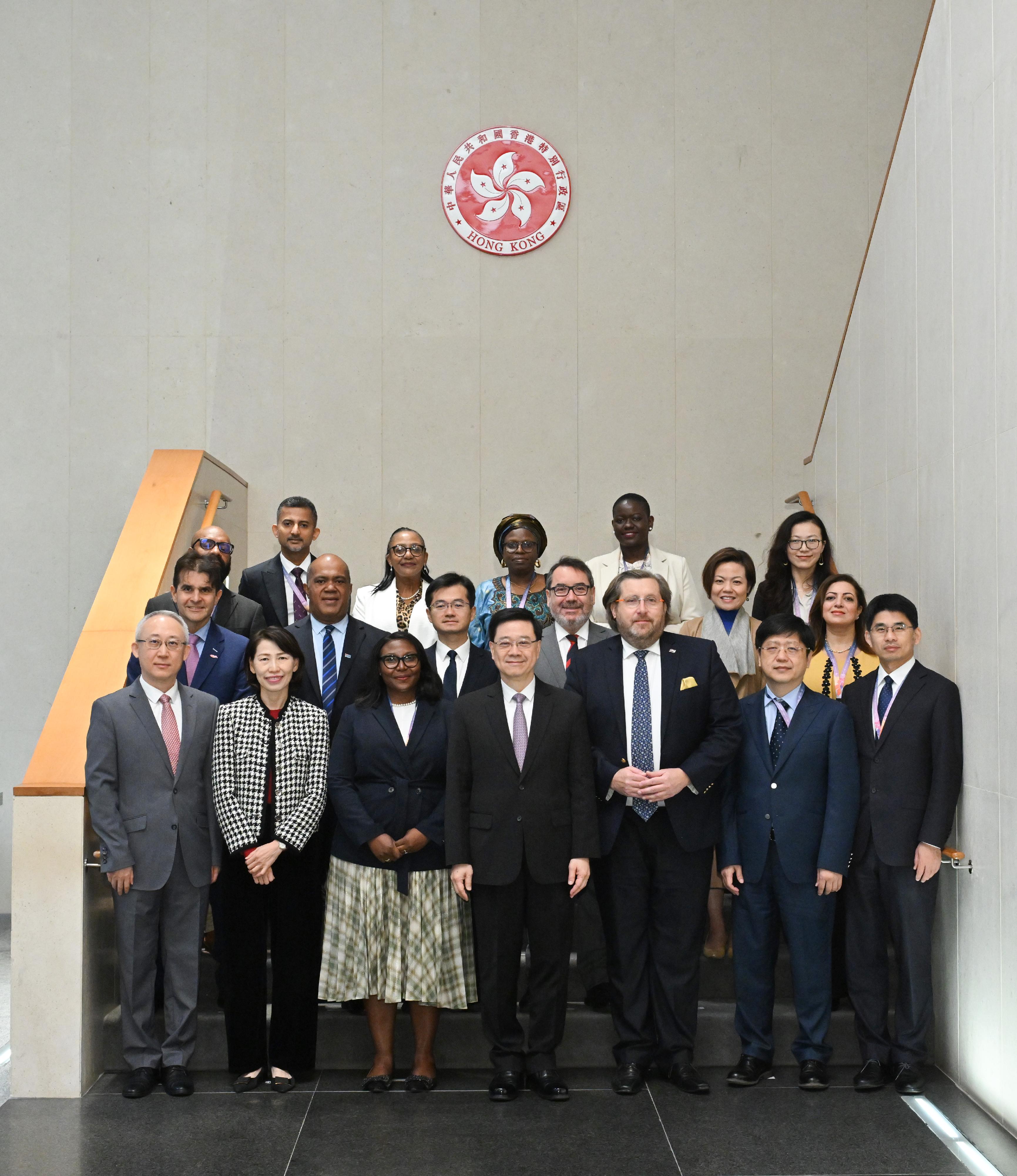 The Chief Executive, Mr John Lee (first row, centre), meets with members of a visiting delegation of overseas government officials today (December 9).