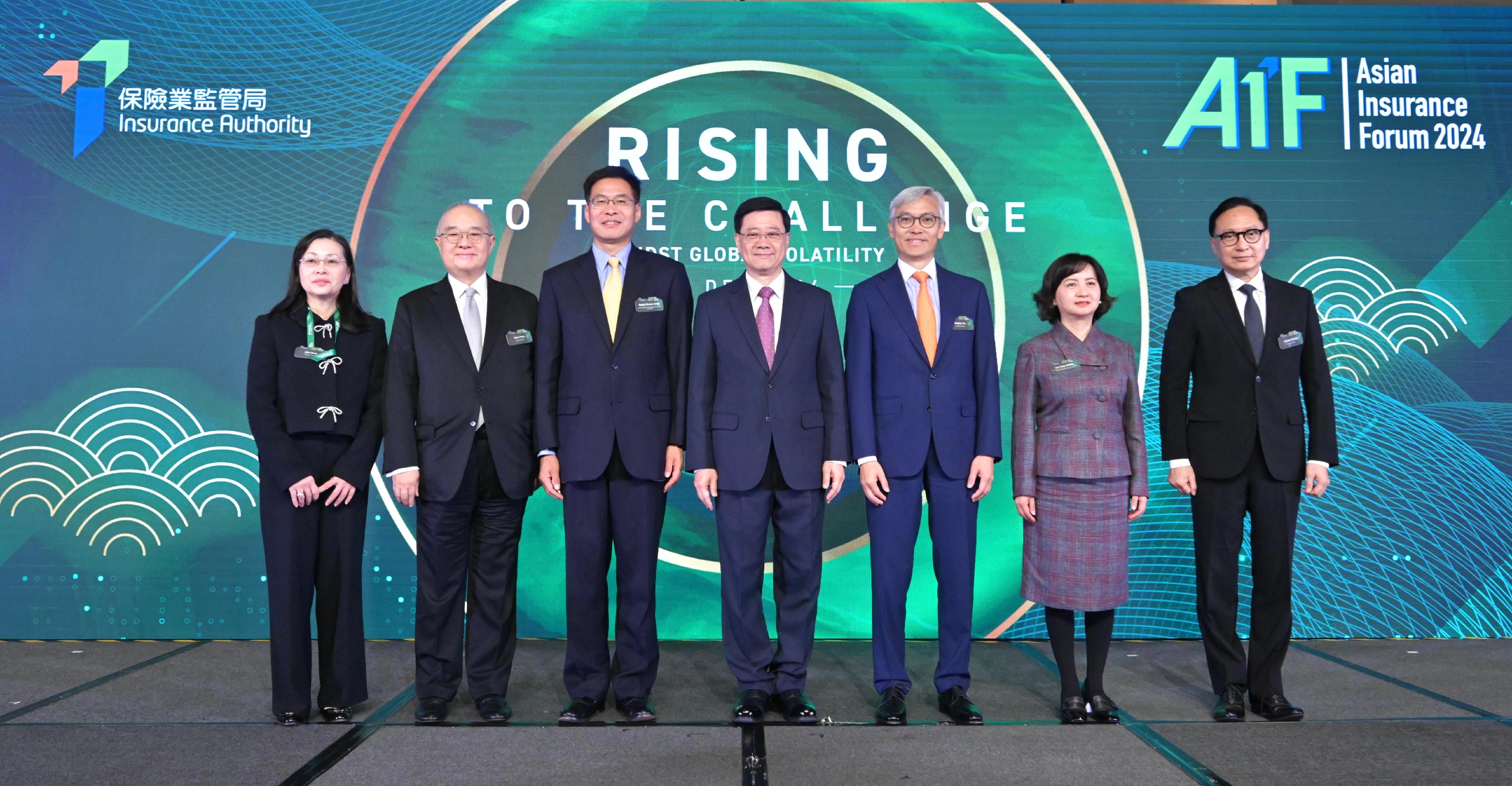 The Chief Executive, Mr John Lee, attended the Asian Insurance Forum 2024 today (December 10). Photo shows Mr Lee (centre); Deputy Director of the Liaison Office of the Central People's Government in the Hong Kong Special Administrative Region Mr Qi Bin (third left); the Chairman of the Insurance Authority, Mr Stephen Yiu (third right); the Chief Executive Officer of the Insurance Authority, Mr Clement Cheung (first right); and other guests at the forum.