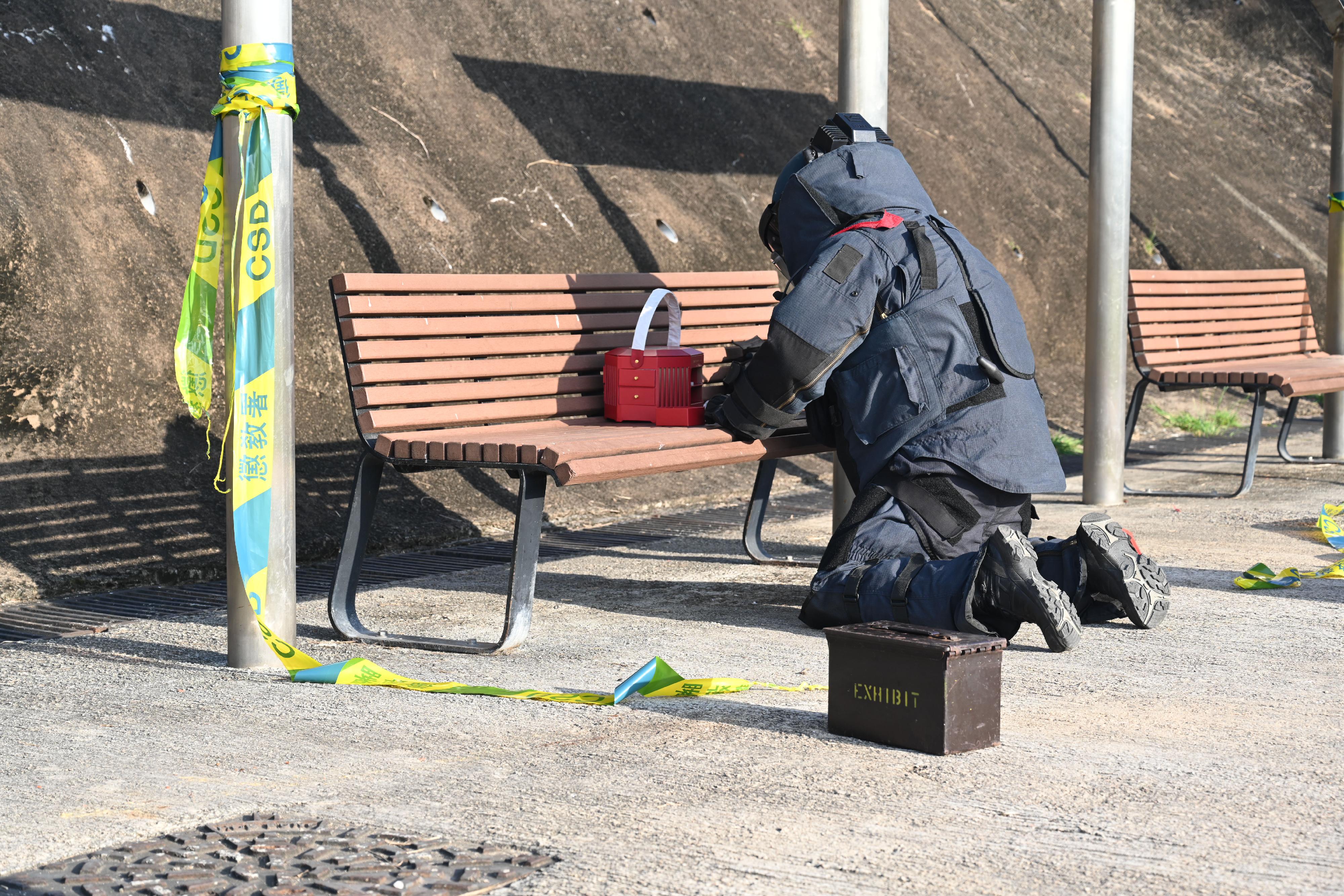 The Correctional Services Department conducted an emergency exercise, code-named Concord XXIII, today (December 11). The exercise simulated a series of incidents, including mass indiscipline of persons in custody, a hostage-taking situation, assembly of members of the public intruding into a restricted area, and the discovery of explosives at Stanley Prison. Photo shows an officer of the Explosive Ordnance Disposal Bureau of the Hong Kong Police Force handling explosives.