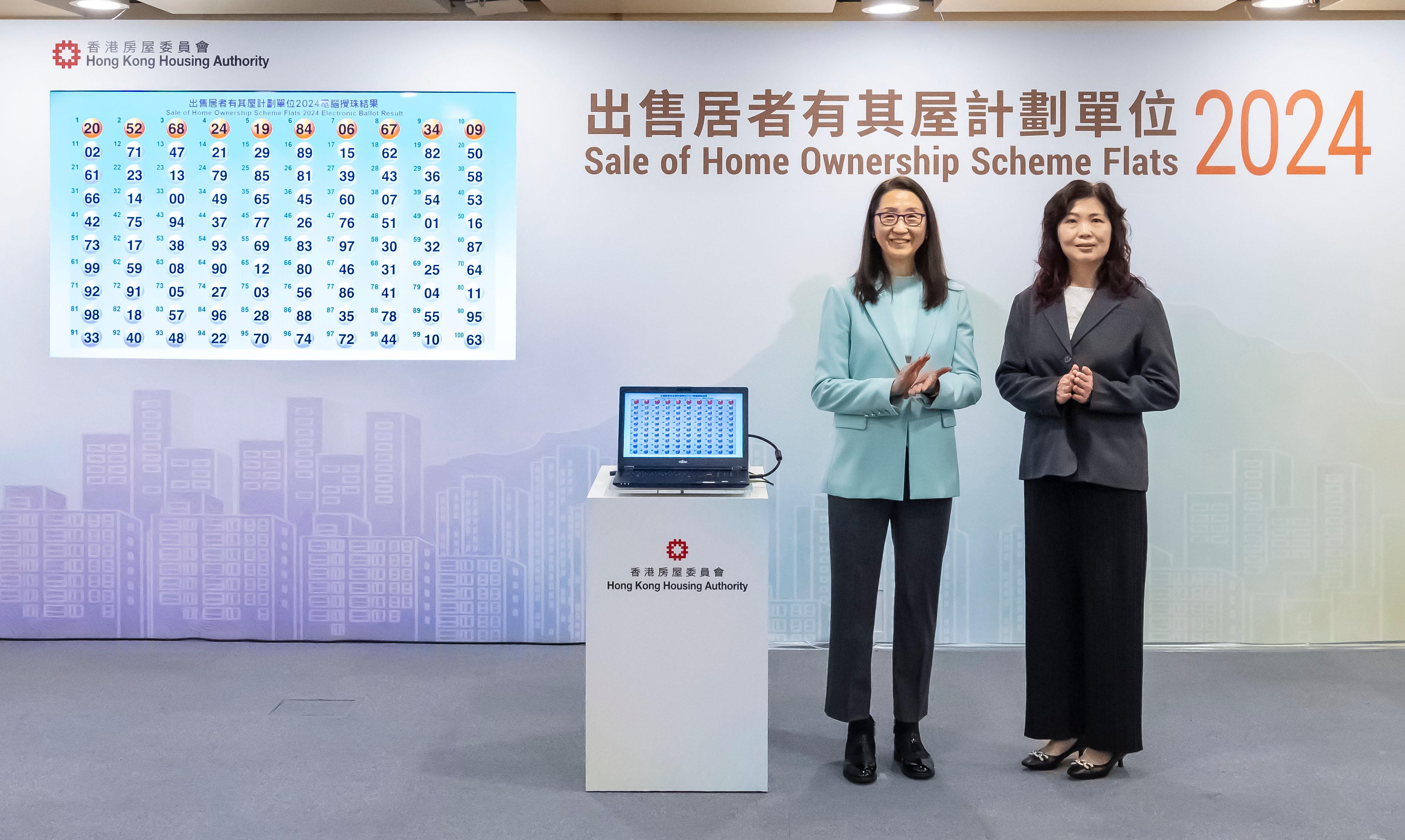 The Chairman of the Subsidised Housing Committee of the Hong Kong Housing Authority, Ms Cleresa Wong (left), accompanied by the Assistant Director of Housing (Housing Subsidies), Ms Carol Kong (right), officiates at the electronic ballot drawing ceremony today (December 12) for the Sale of Home Ownership Scheme Flats 2024. The ballot results will determine the applicants' priority sequence based on the last two digits of the application numbers.