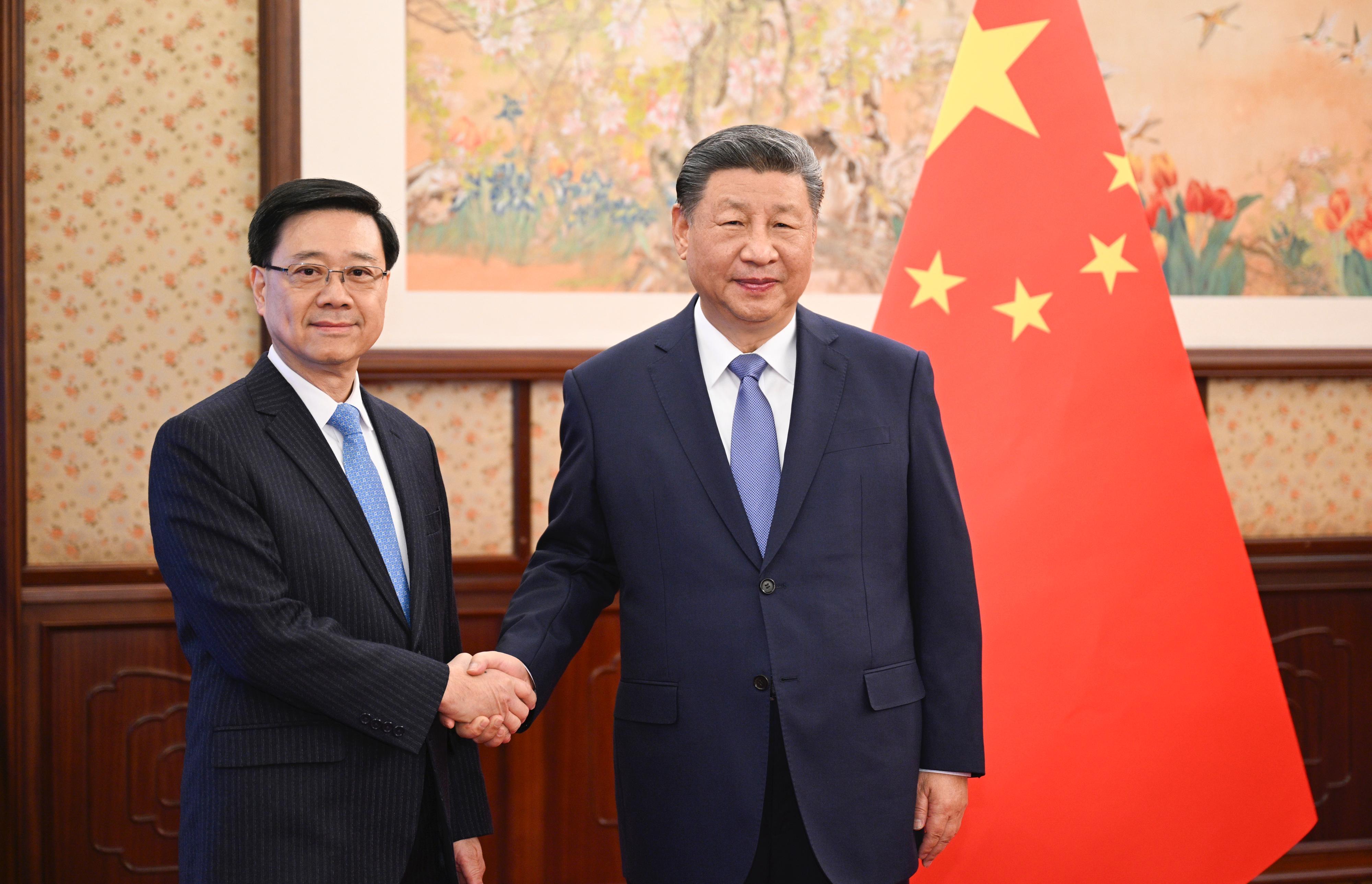 The Chief Executive, Mr John Lee (left), briefed President Xi Jinping (right) in Beijing today (December 13) on the latest economic, social and political situation in Hong Kong. They are pictured before the meeting.