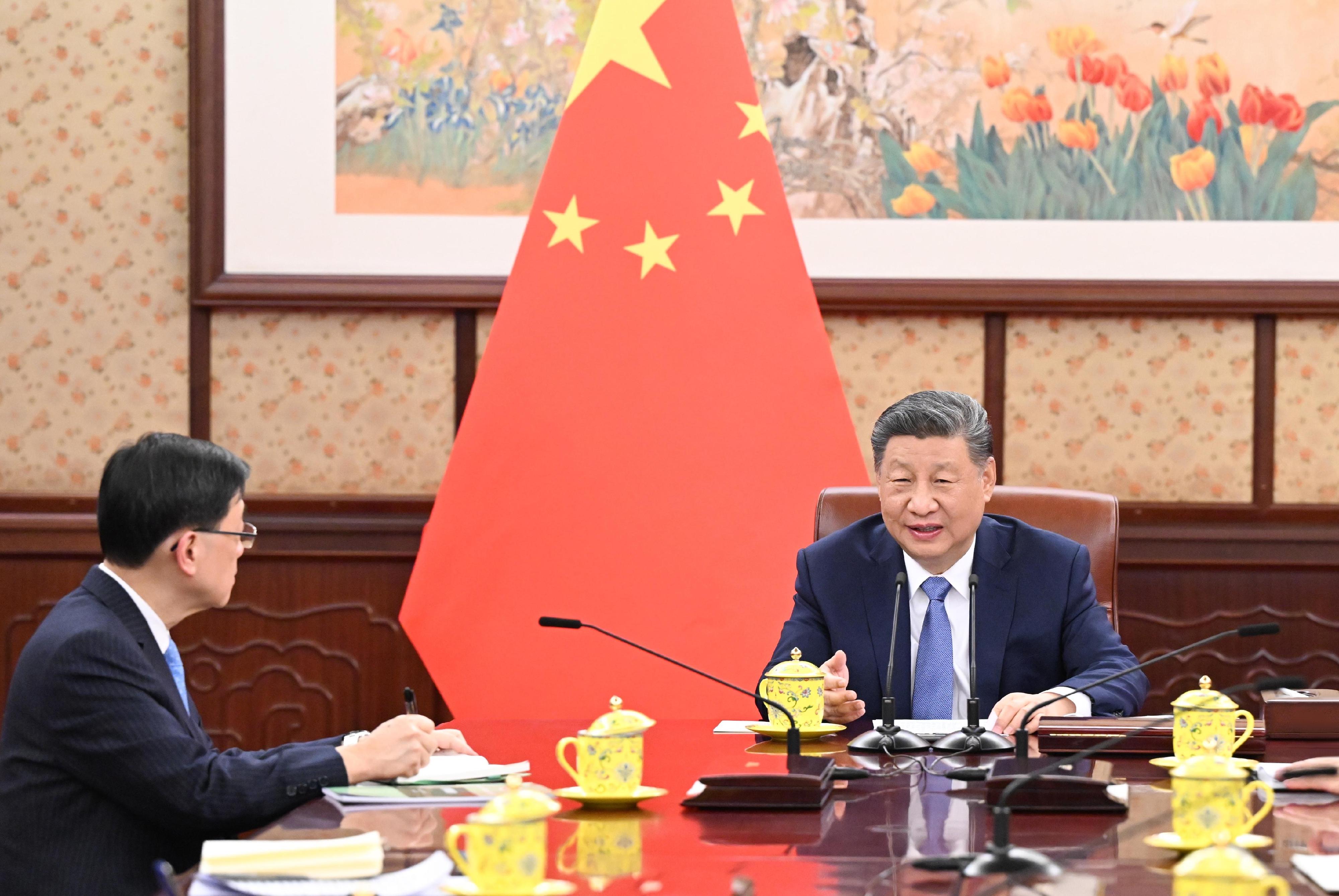 The Chief Executive, Mr John Lee (left), briefs President Xi Jinping (right) in Beijing today (December 13) on the latest economic, social and political situation in Hong Kong.