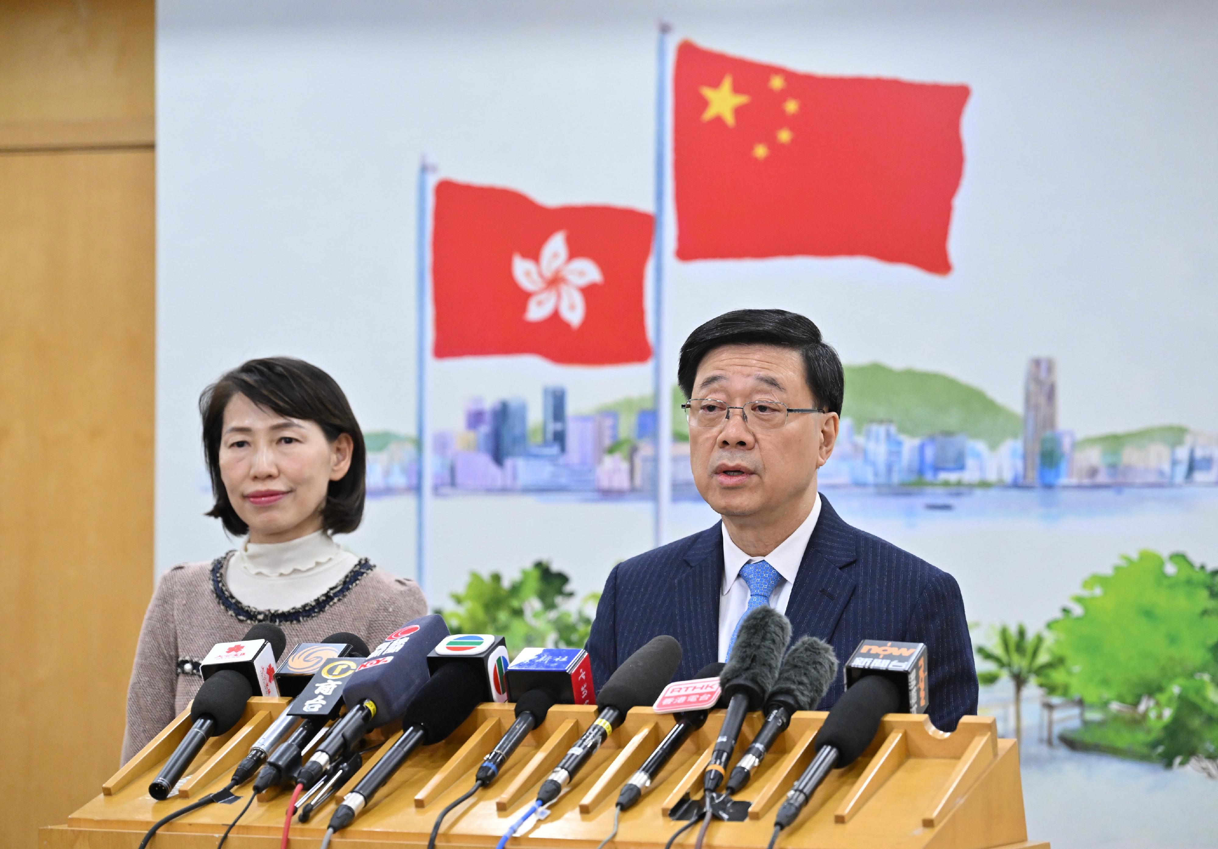 The Chief Executive, Mr John Lee (right), meets the media in Beijing after reporting to President Xi Jinping on work today (December 13). Looking on is the Director of the Chief Executive's Office, Ms Carol Yip (left).