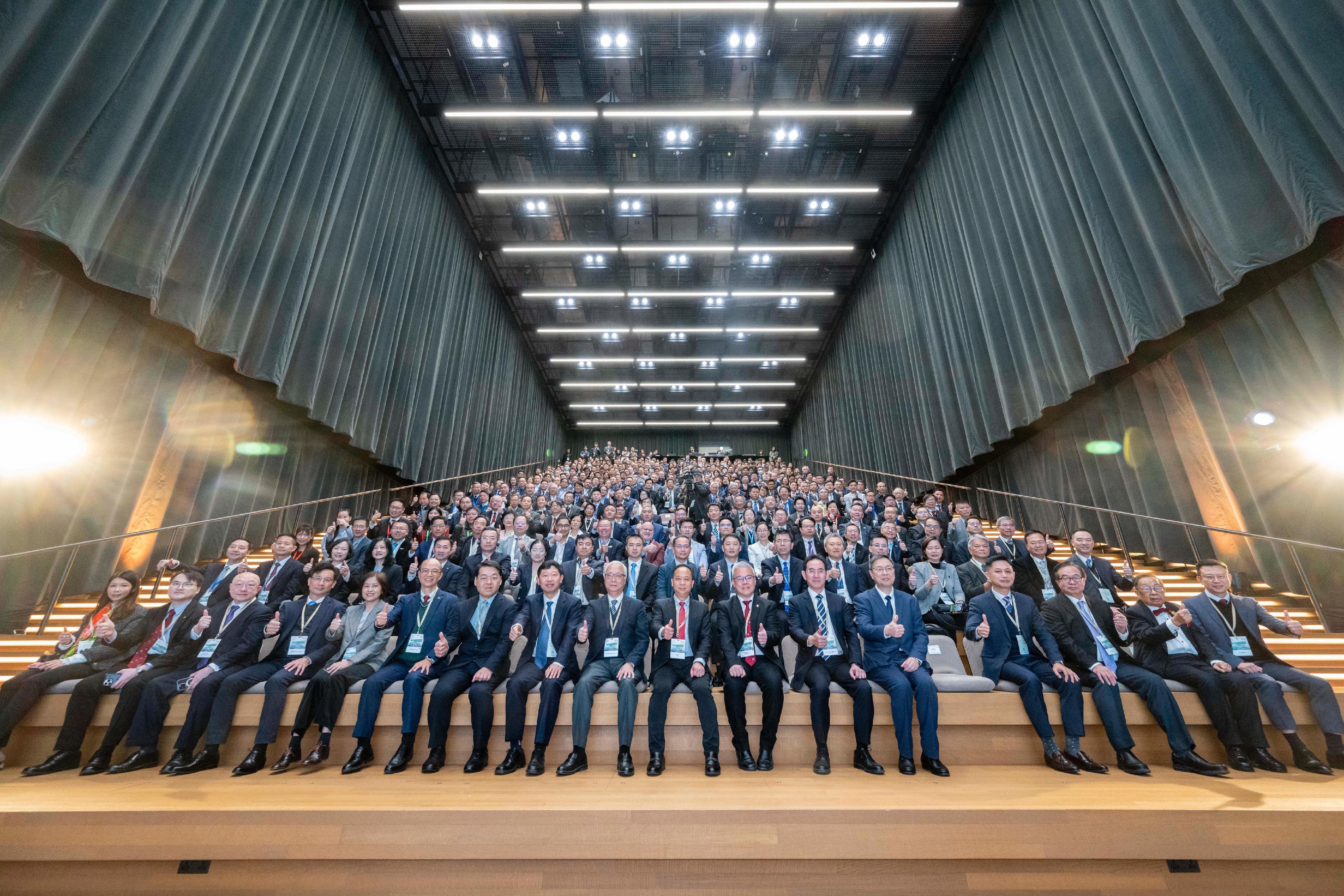 The EMSD Symposium 2024, organised by the Electrical and Mechanical Services Department, was held today (December 16). Photo shows the Deputy Director-General of the Department of Educational, Scientific and Technological Affairs of the Liaison Office of the Central People's Government in the Hong Kong Special Administrative Region, Mr Ye Shuiqiu  (first row, eighth right); the Secretary for Environment and Ecology, Mr Tse Chin-wan (first row, centre); the Director of Electrical and Mechanical Services, Mr Poon Kwok-ying (first row, seventh right); and the Under Secretary for Development, Mr David Lam (first row, sixth right), at the symposium with the guests.