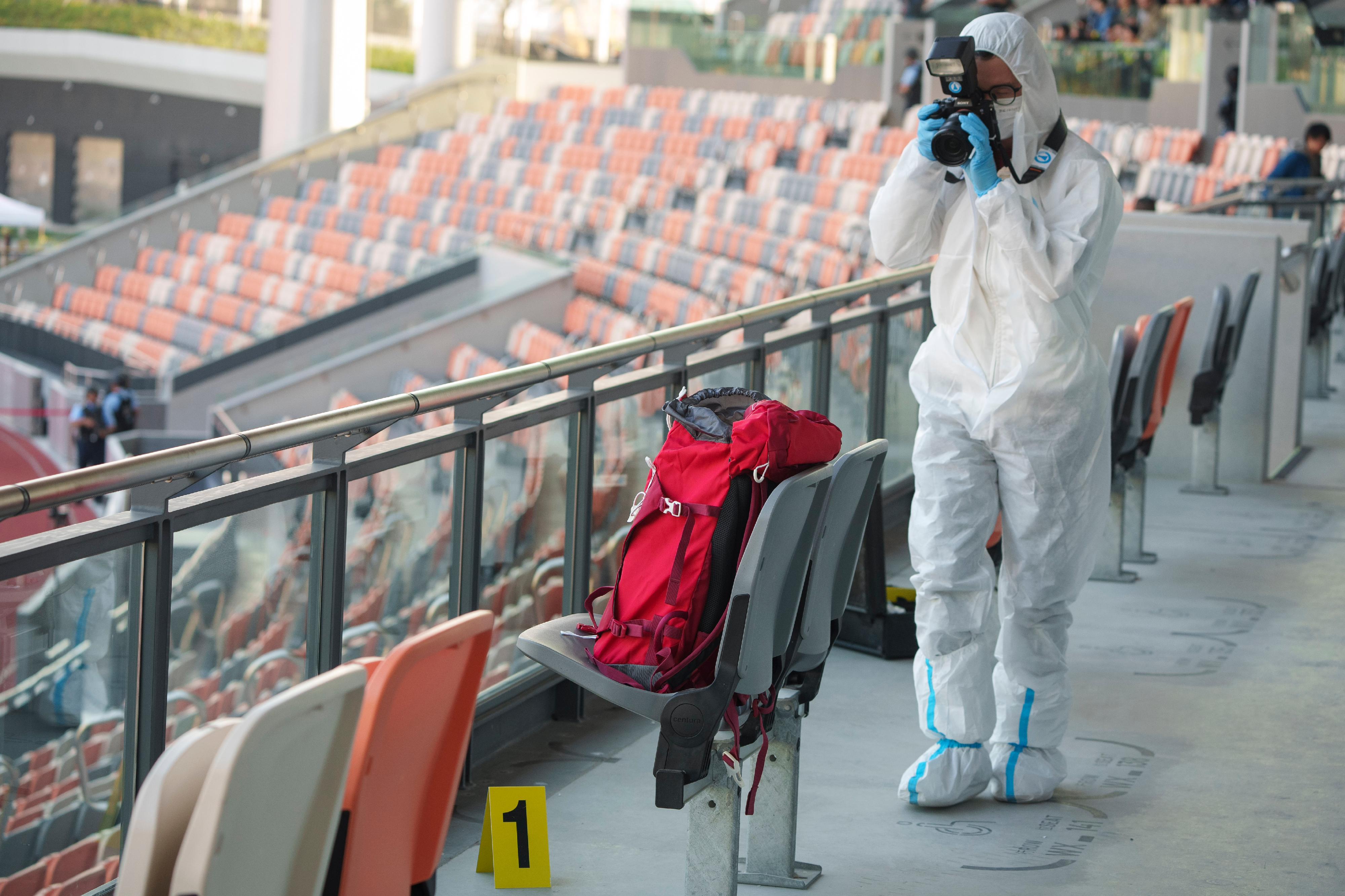 The Inter-departmental Counter Terrorism Unit (ICTU) conducted an inter-departmental counter-terrorism exercise, codenamed “WISDOMLIGHT”, at the Kai Tak Youth Sports Ground this afternoon (December 17). Photo shows the officers of the Government Laboratory collecting forensic evidence at the scene.