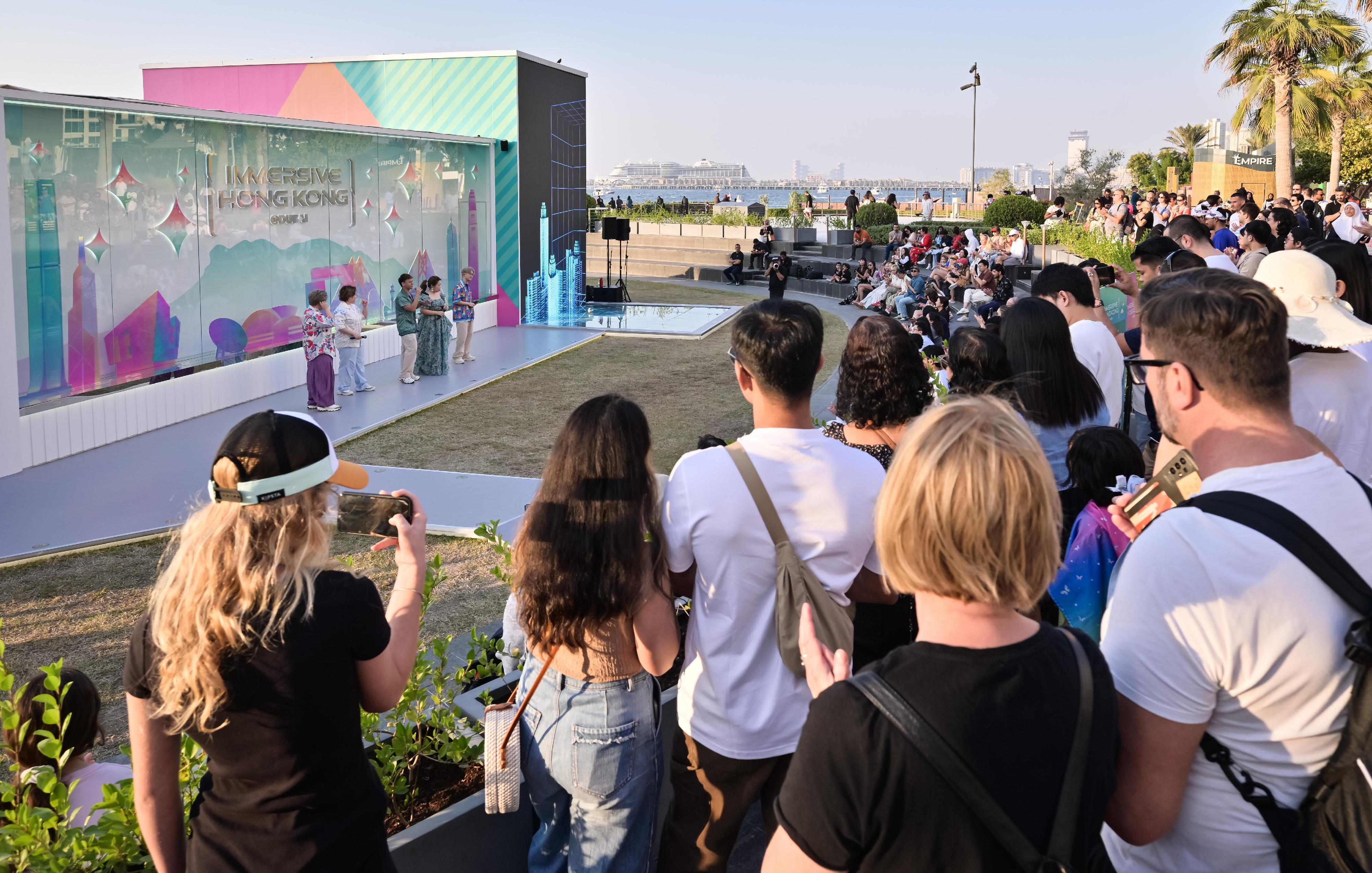 The "Immersive Hong Kong" roving exhibition, which showcases Hong Kong's new attractions, advantages and opportunities with art technology, opened in Dubai, the United Arab Emirates, today (December 20) as part of a promotional campaign organised by the Information Services Department of the Hong Kong Special Administrative Region Government. Photo shows a pop music concert by Senza A Cappella at the exhibition venue.