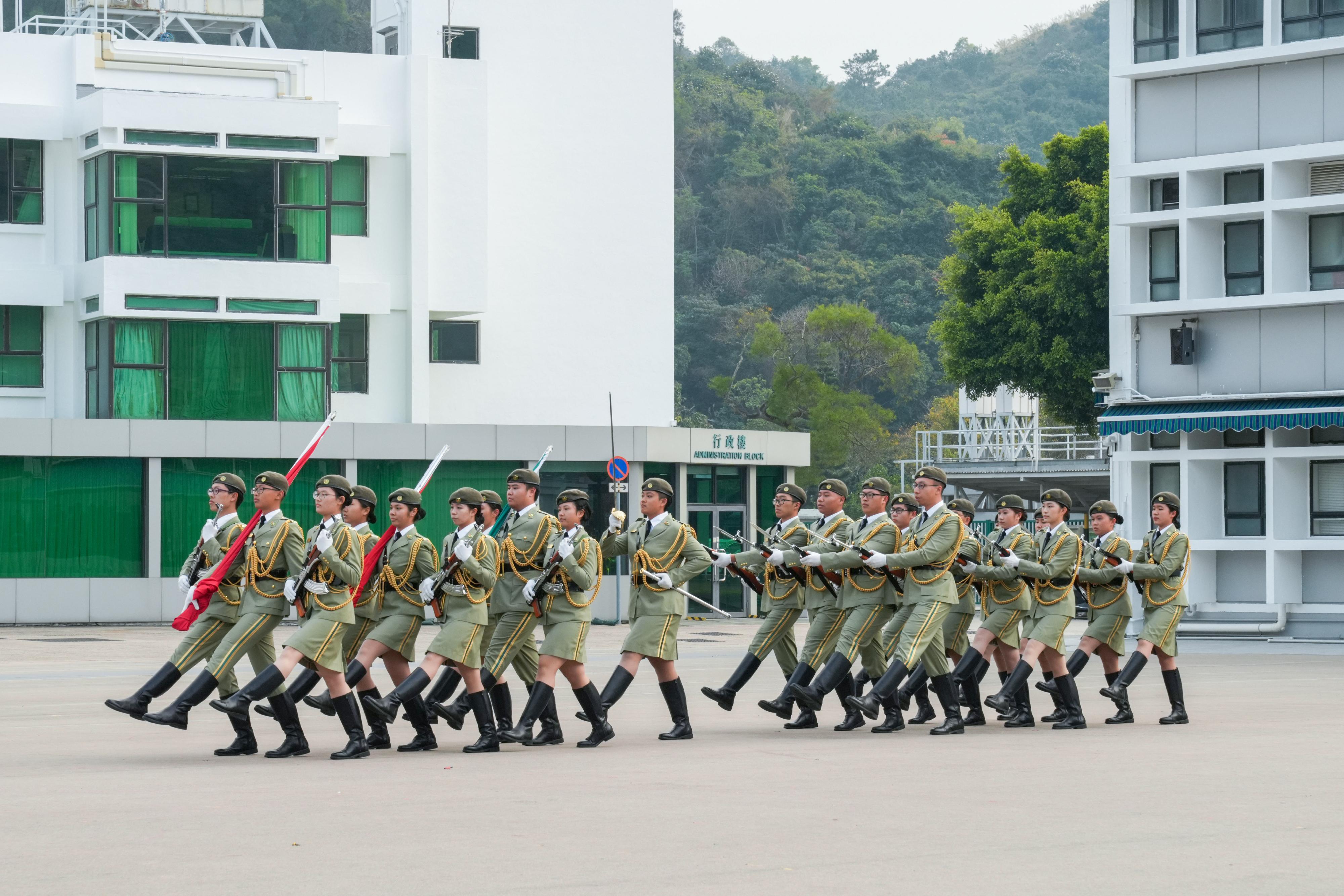 Hong Kong Customs held a graduation parade for the Customs Youth Leader Corps Winter Training Camp 2024 and "YES Buddy" AI Robot Launching Ceremony at the Hong Kong Customs College today (December 27). Photo shows the Foot Drill and Flag Party of the Customs Youth Leader Corps performing the flag-raising ceremony.