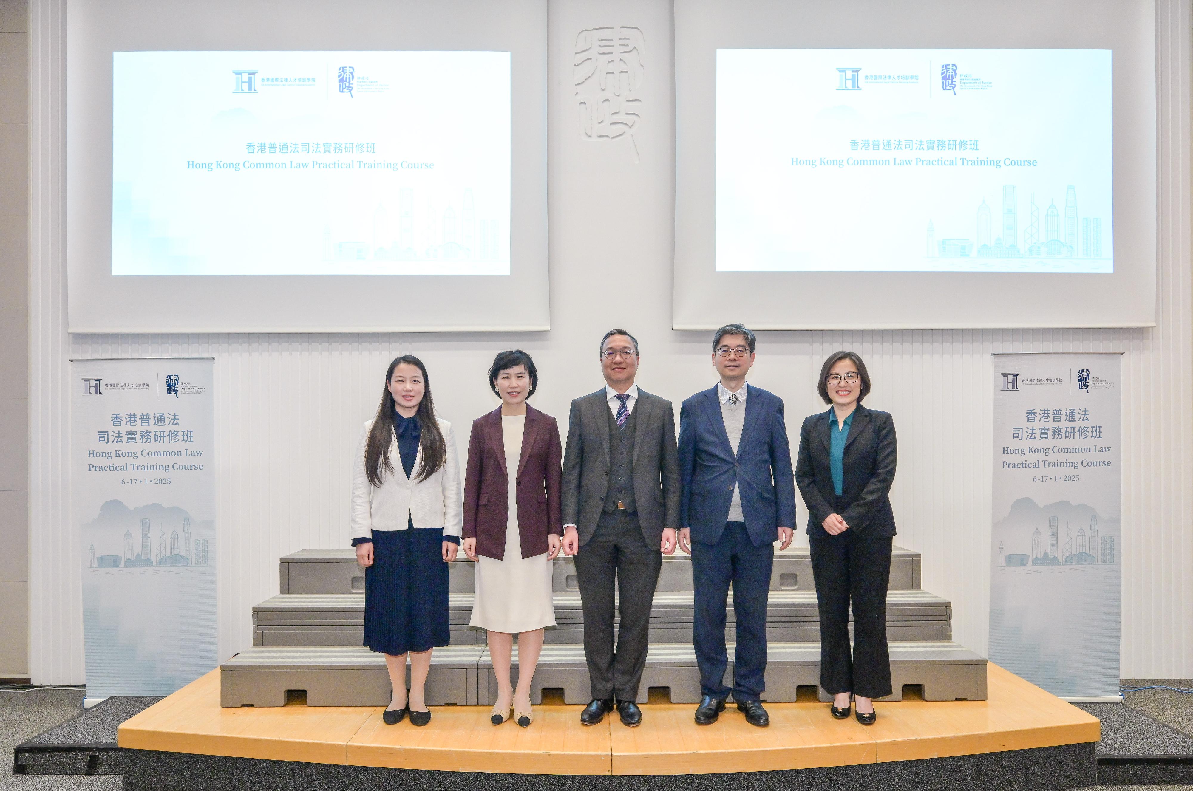 The first Hong Kong Common Law Practical Training Course, co-organised by the Hong Kong International Legal Talents Training Academy and the Supreme People's Court (SPC), officially commenced today (January 6). Photo shows the Secretary for Justice, Mr Paul Lam, SC (centre); Deputy Director General of the Research Office of the SPC Ms Si Yanli (second left); the Director of the Hong Kong and Macao Judicial Affairs Office of the Research Office of the SPC, Ms Zhang Xinmeng (first left); the Law Officer (International Law) of the Department of Justice (DoJ), Dr James Ding (second right); and the Director of the Hong Kong International Legal Talents Training Office of the DoJ, Dr Yang Ling (first right); at the opening ceremony of the course.
