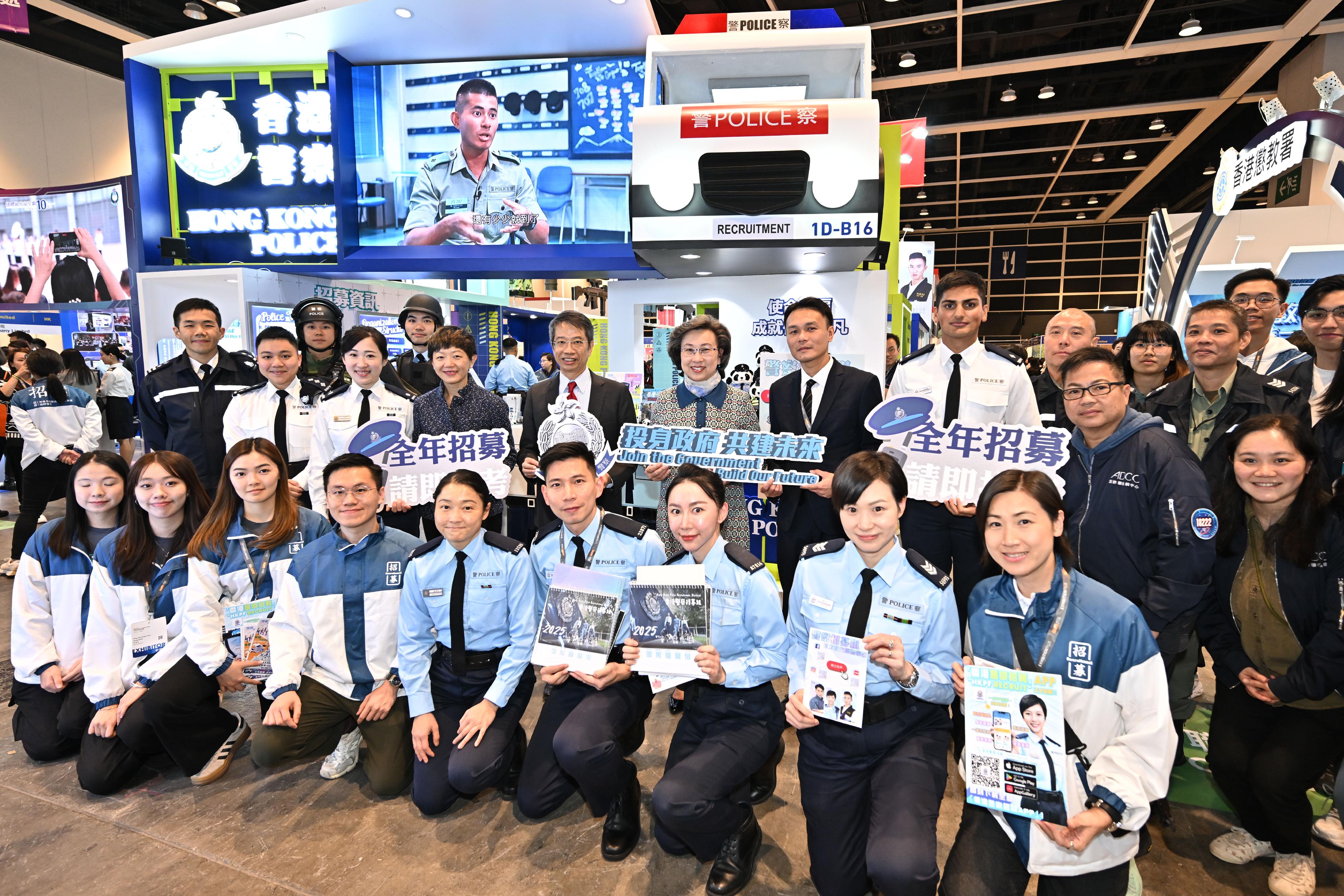 The Civil Service Bureau has curated an exhibition area at the Education & Careers Expo 2025 from today (January 16) for four consecutive days to introduce the work of over 50 government grades and provide the public with information on civil service recruitment to enhance job seekers' understanding of government jobs. The Secretary for the Civil Service, Mrs Ingrid Yeung (second row, centre); and the Permanent Secretary for the Civil Service, Mr Clement Leung (second row, fourth left), are pictured with the officers of the Hong Kong Police Force at the department's booth.