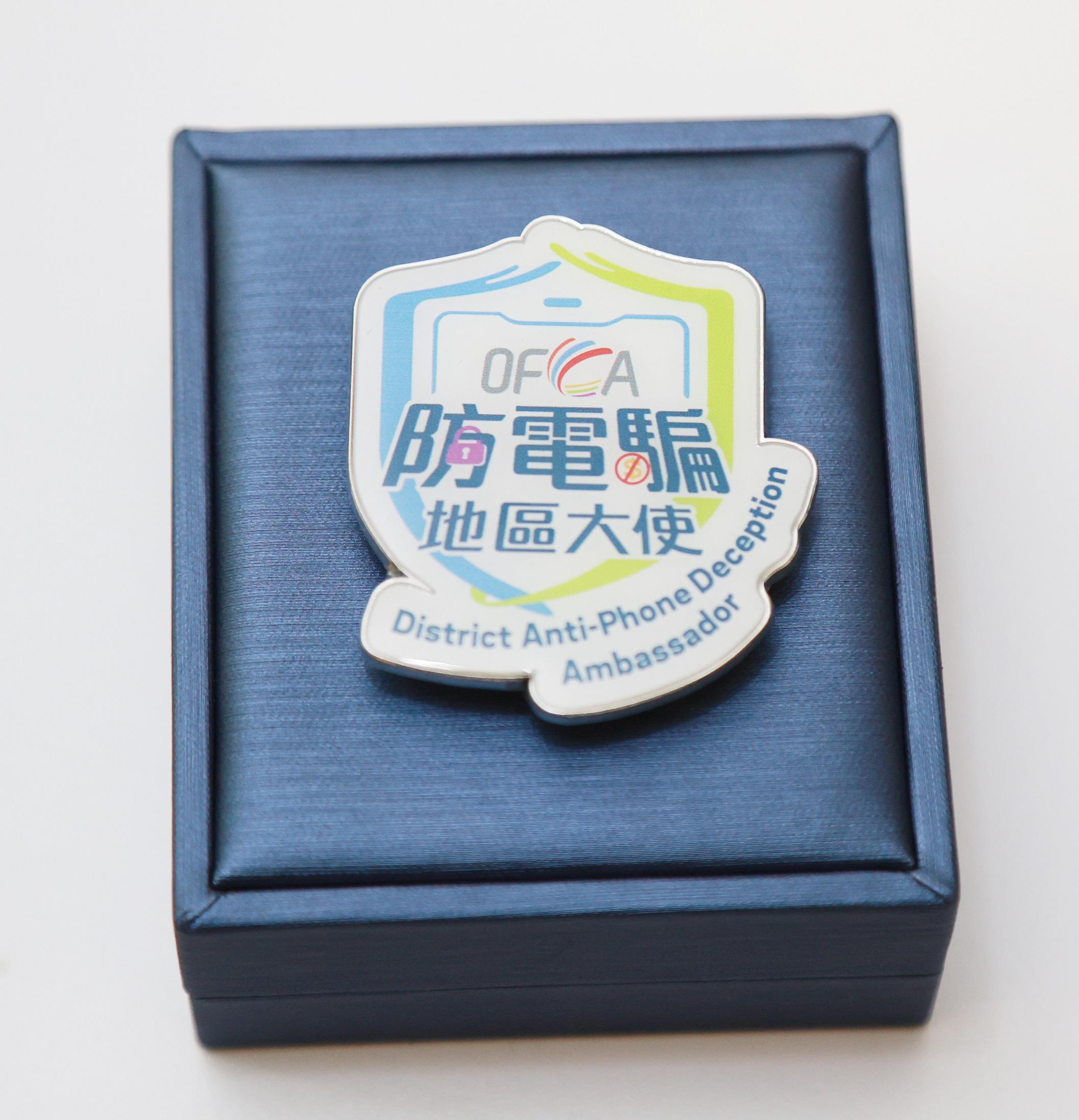 The Office of the Communications Authority held the Launch Ceremony of the District Anti-Phone Deception Ambassador Scheme today (January 16). Photo shows the badge specially designed for the Scheme.