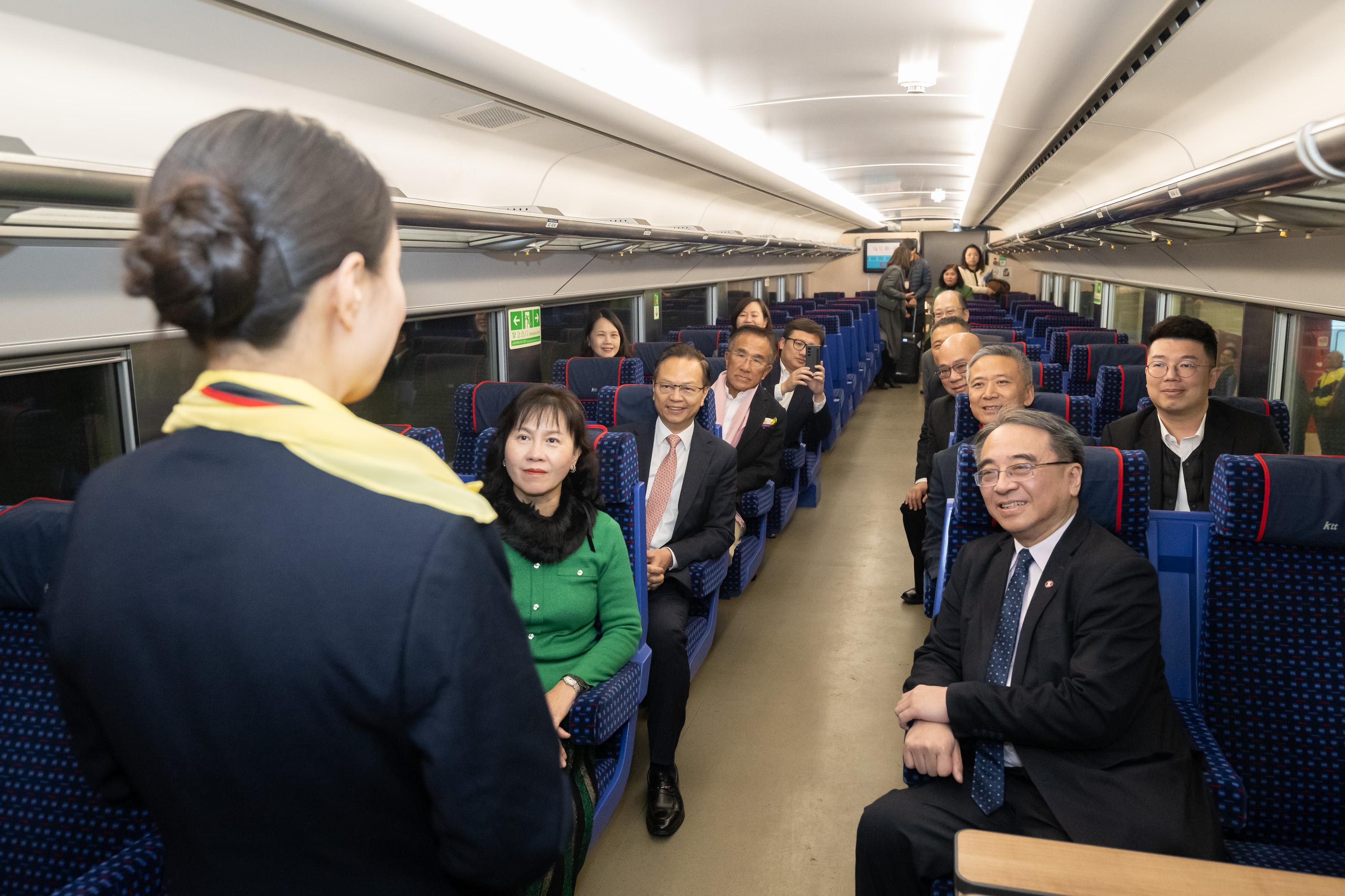 The Legislative Council Panel on Transport visits the Station Rail Voyage Exhibition of the MTR Corporation Limited (MTRCL) at Hung Hom Station today (January 17), which features new exhibits including the Kowloon-Canton Railway Through Train (Ktt). Photo shows Members receiving a briefing by the MTRCL representatives on the features of the Ktt.