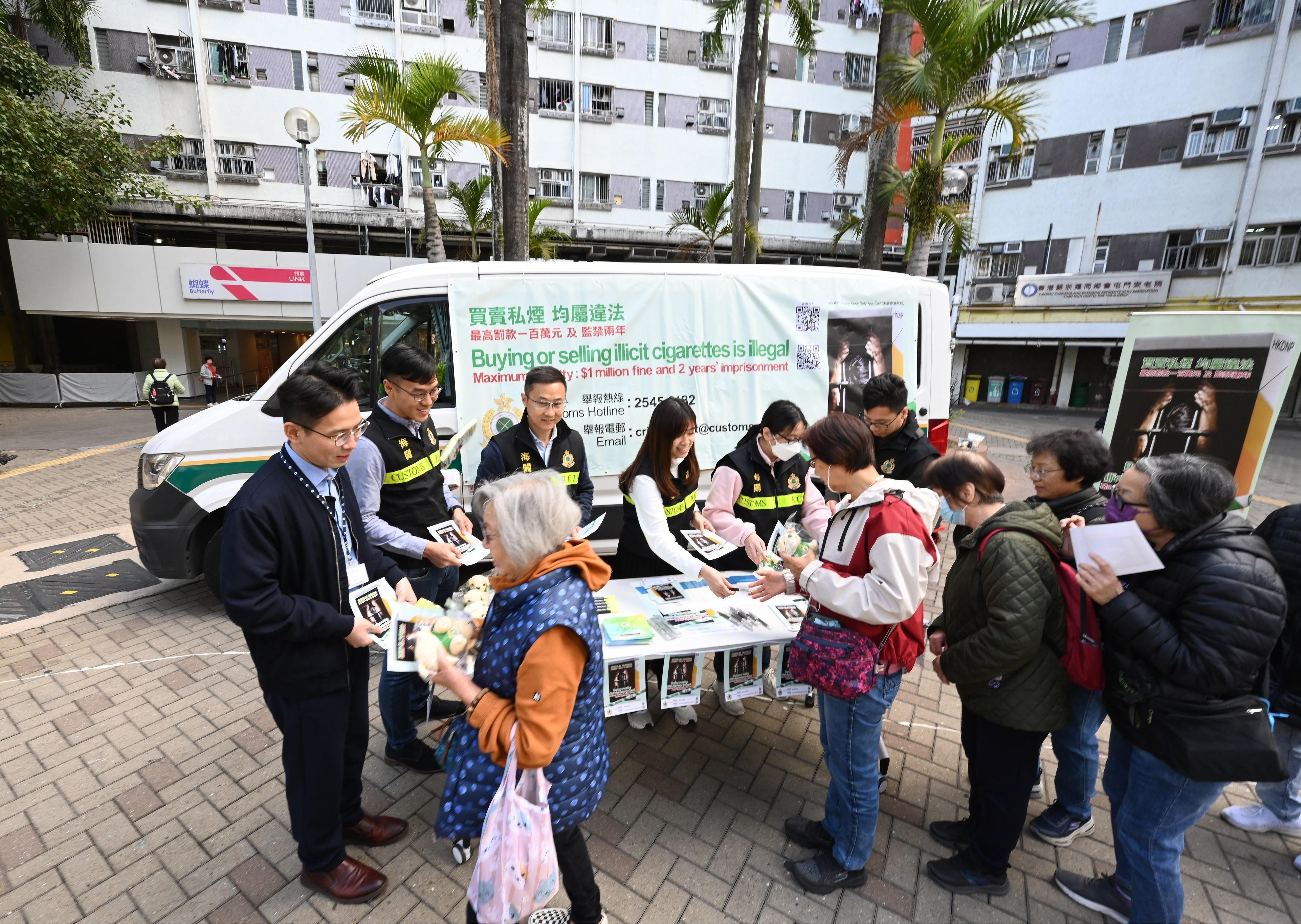 香港海關一連兩日（一月二十一日和二十二日）聯同多名屯門區區議員和多個政府部門進行聯合反私煙宣傳活動，向市民傳遞反私煙信息。圖示海關人員向市民派發宣傳單張。
