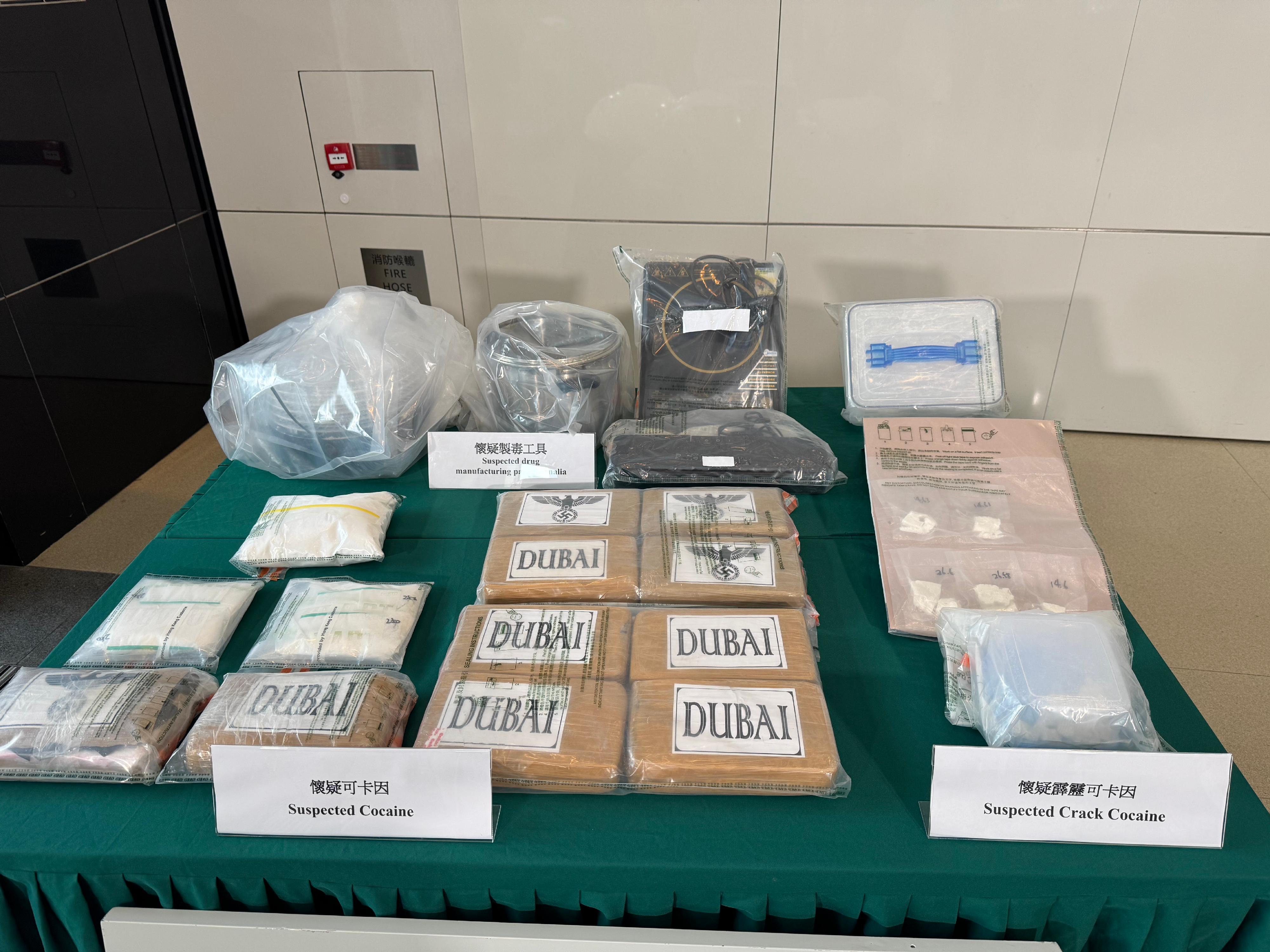 Hong Kong Customs yesterday (January 23) seized about 11 kilograms of suspected cocaine and 200 grams of suspected crack cocaine in To Kwa Wan and Tai Kok Tsui.  The total estimated market value was about $9.6 million. Photo shows the suspected cocaine, the suspected crack cocaine and suspected drug manufacturing paraphernalia seized.