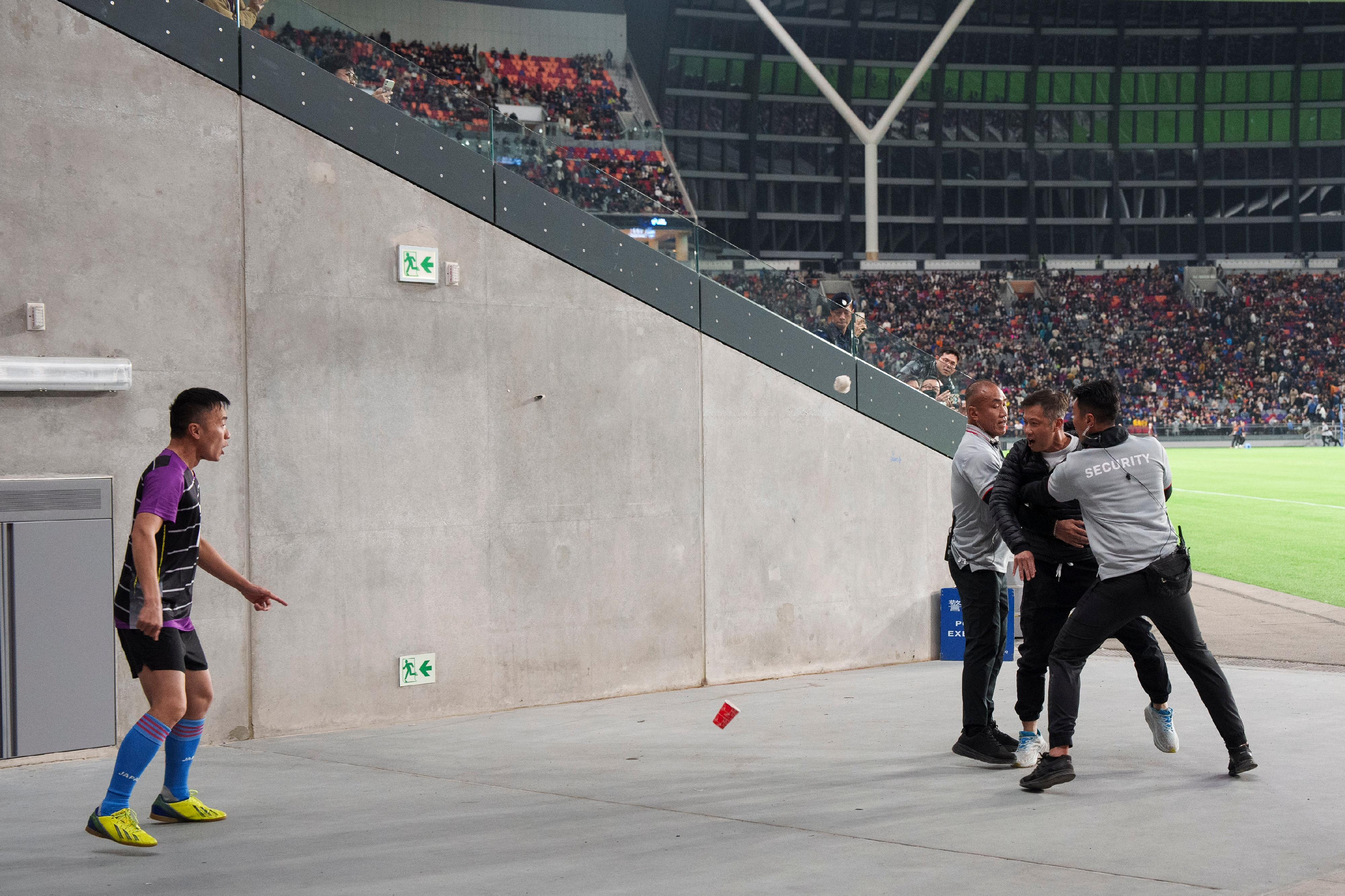 A large-scale stress test was conducted at Kai Tak Sports Park today (February 4). Photo shows officers simulating the interception of an individual who has thrown an object at a player.