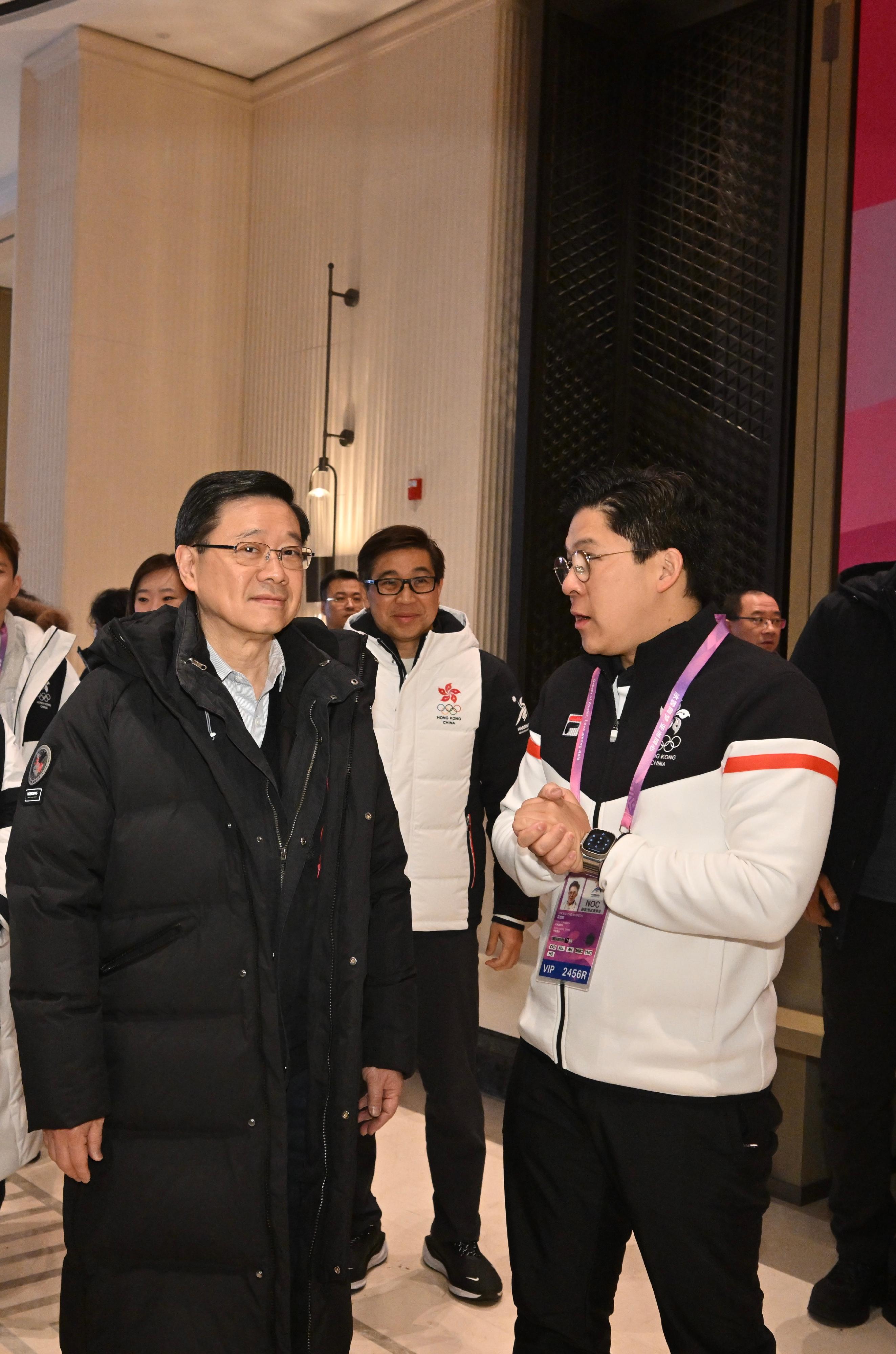 The Chief Executive, Mr John Lee, continued his visit programme in Harbin today (February 8). Photo shows Mr Lee (left) visiting members of the Hong Kong, China Delegation at the athletes' village of the 9th Asian Winter Games Harbin 2025 and learning about their preparations. Looking on is Vice President of the Sports Federation & Olympic Committee of Hong Kong, China and the Chef de Mission of the Hong Kong, China Delegation to the 9th Asian Winter Games Harbin 2025, Mr Kenneth Fok (right).