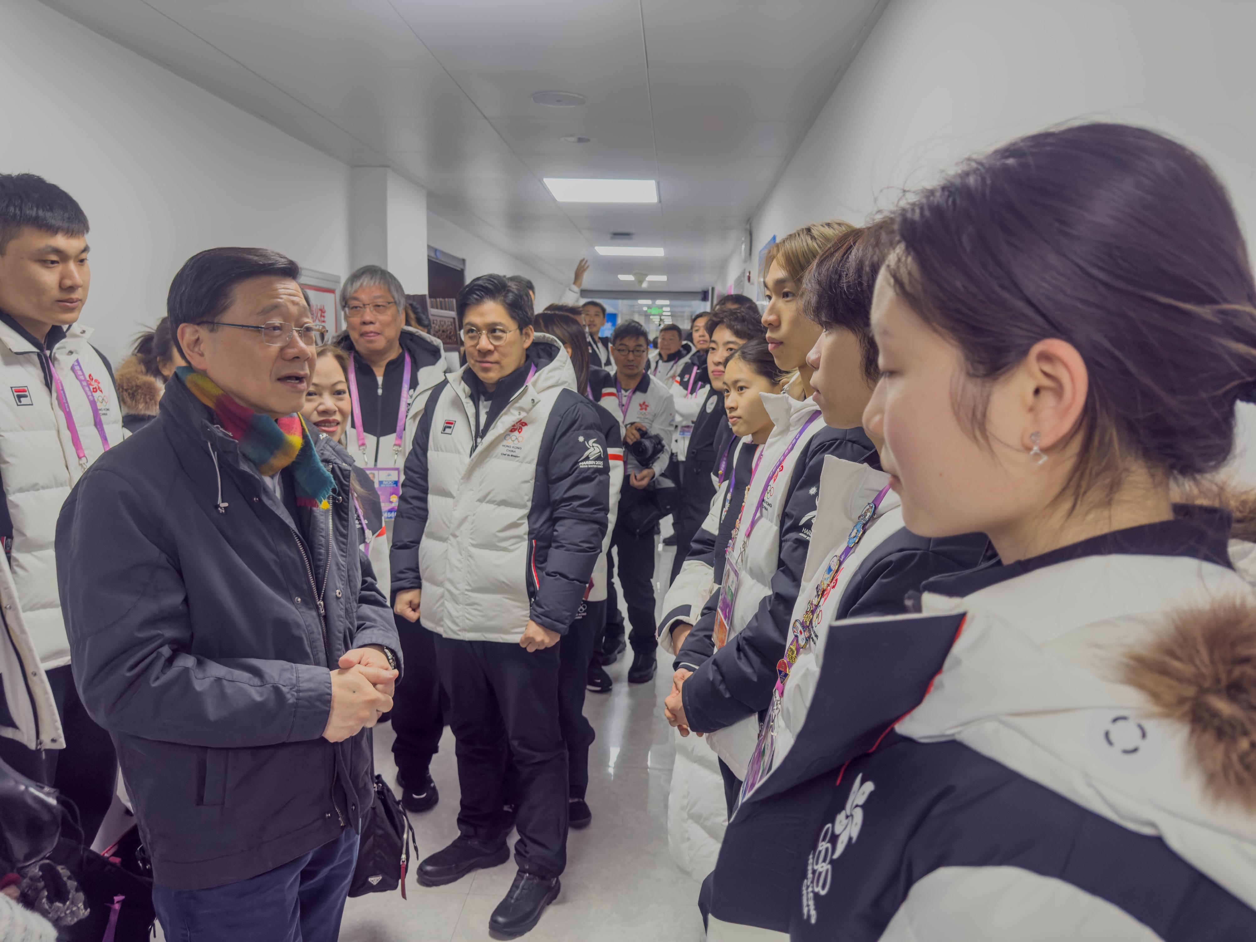 The Chief Executive, Mr John Lee, continued his visit programme in Harbin today (February 8). Photo shows Mr Lee (second left) interacting with Hong Kong athletes after watching a competition at the 9th Asian Winter Games Harbin 2025.