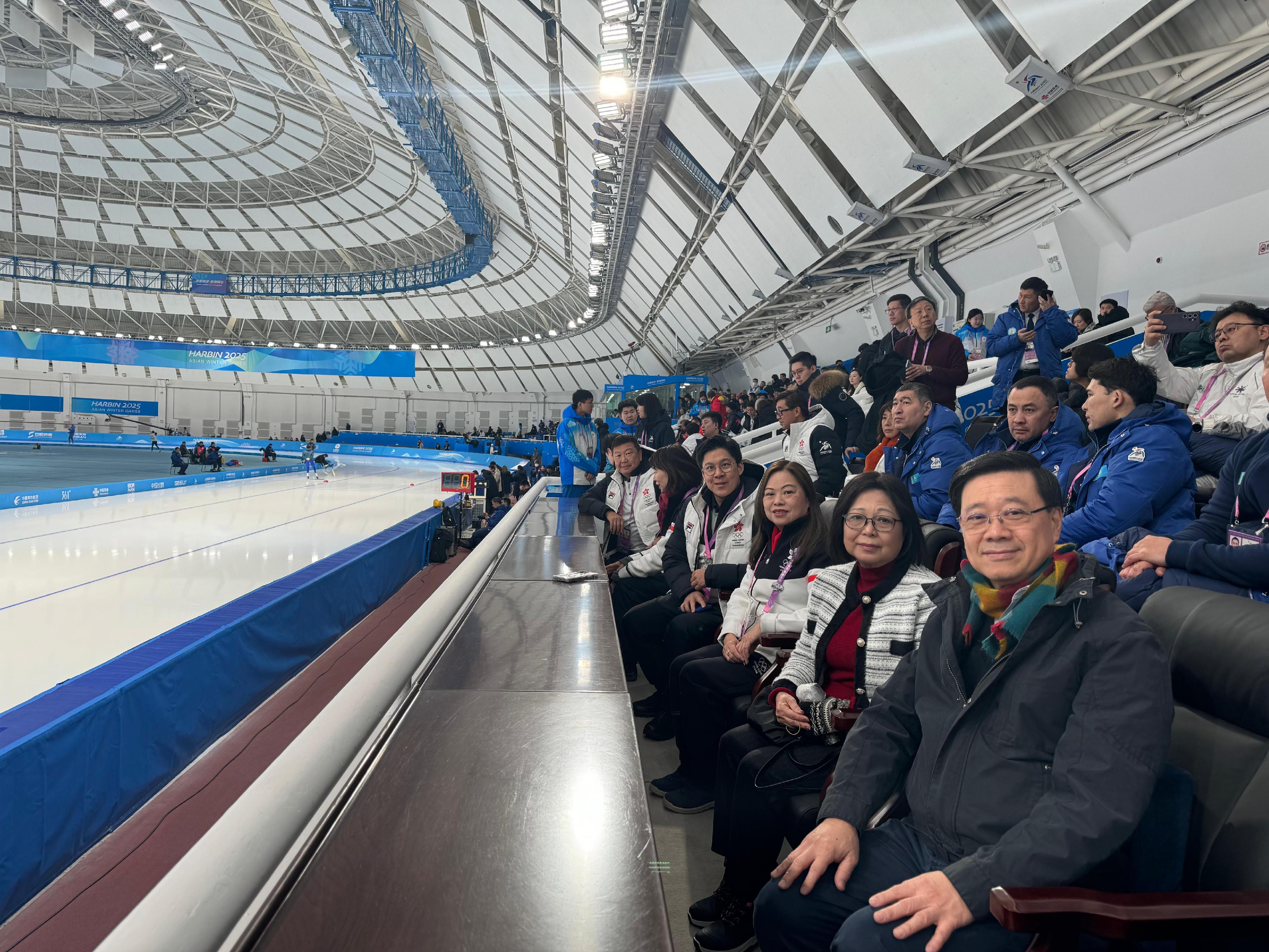 The Chief Executive, Mr John Lee, continued his visit programme in Harbin today (February 8). Photo shows Mr Lee (first right) and his wife Mrs Janet Lee (second right), watching a competition at the 9th Asian Winter Games Harbin 2025 and cheering for Hong Kong athletes. Looking on is the Secretary for Culture, Sports and Tourism, Miss Rosanna Law (third right).