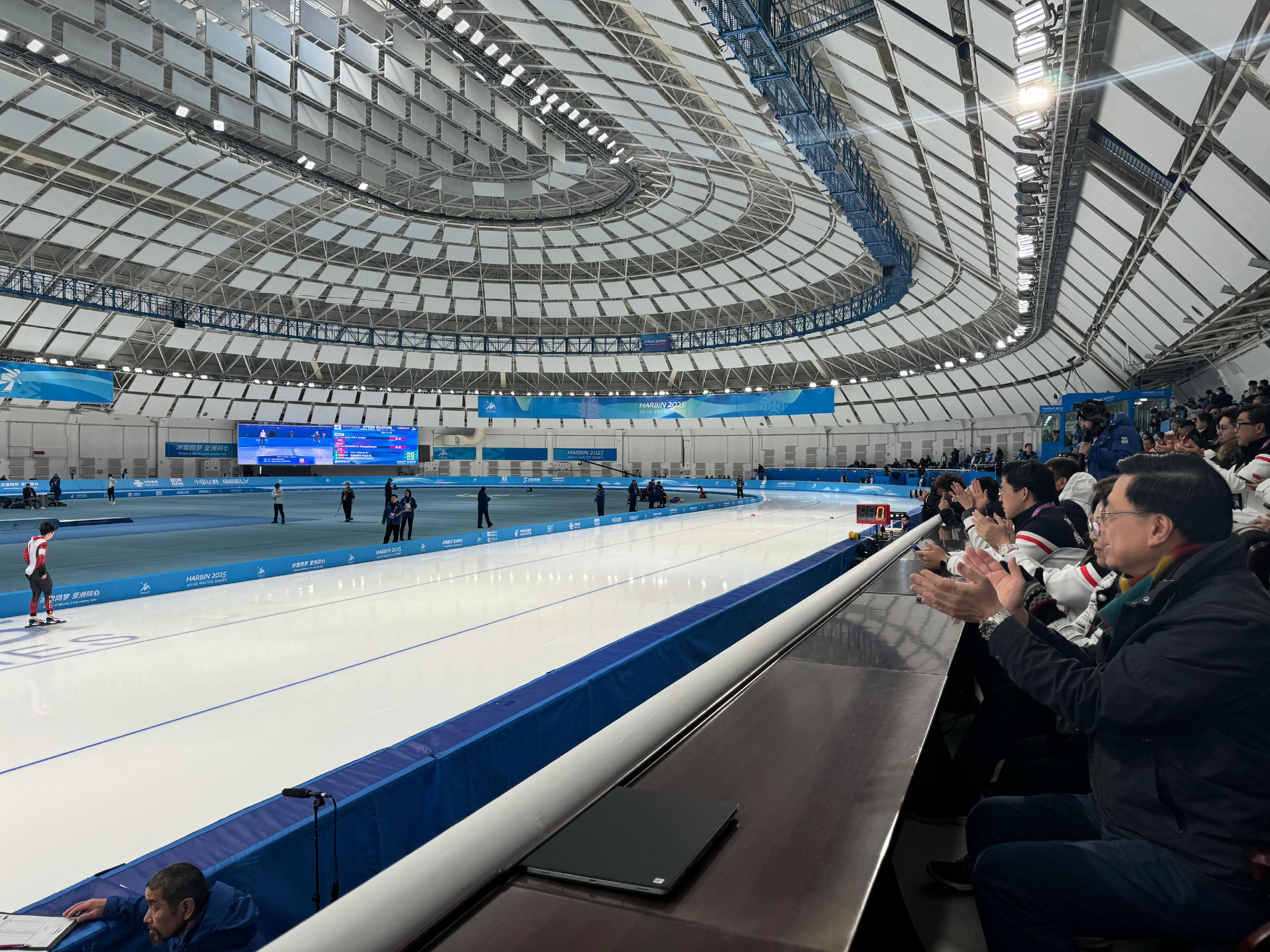 The Chief Executive, Mr John Lee, continued his visit programme in Harbin today (February 8). Photo shows Mr Lee (first right) and his wife Mrs Janet Lee (second right), watching a competition at the 9th Asian Winter Games Harbin 2025 and cheering for Hong Kong athletes. 