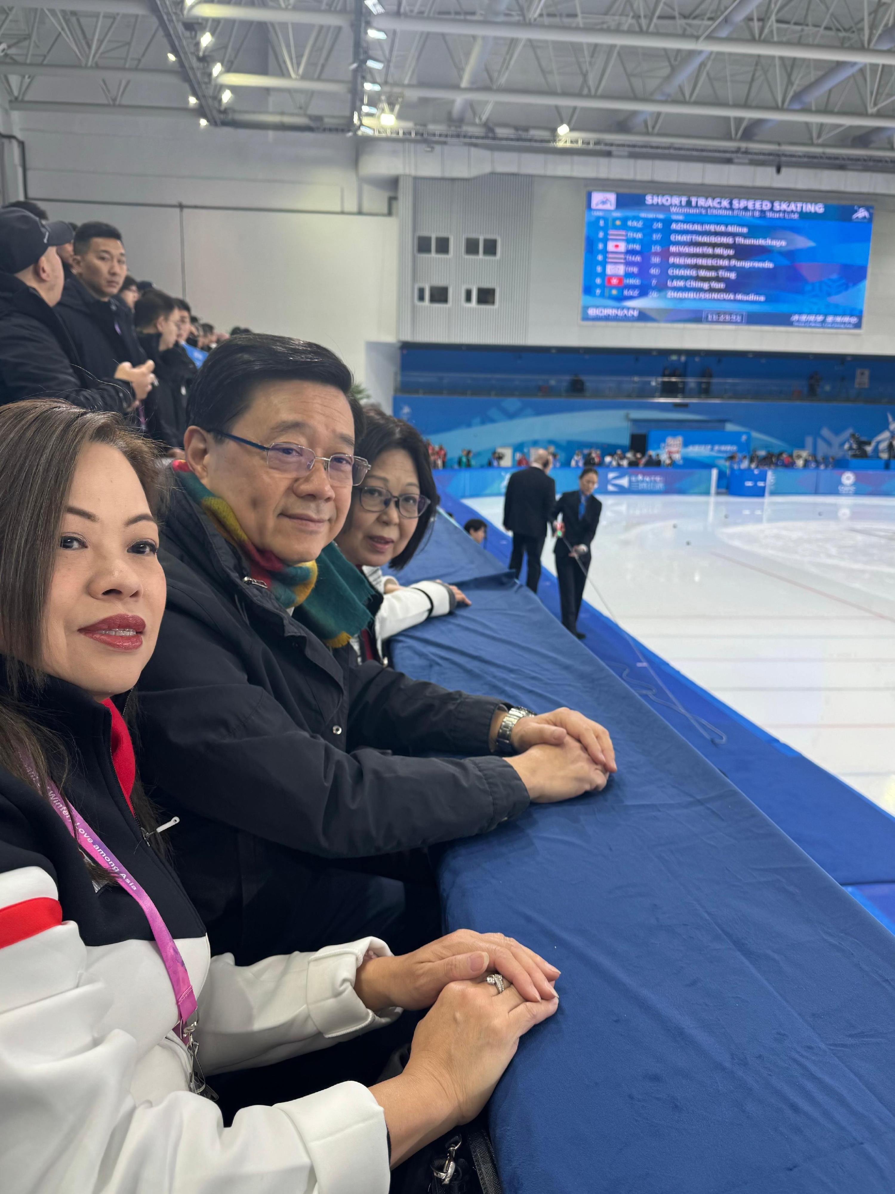 The Chief Executive, Mr John Lee, continued his visit programme in Harbin today (February 8). Photo shows Mr Lee (centre) and his wife Mrs Janet Lee (right), watching a competition at the 9th Asian Winter Games Harbin 2025 and cheering for Hong Kong athletes. Looking on is the Secretary for Culture, Sports and Tourism, Miss Rosanna Law (left).