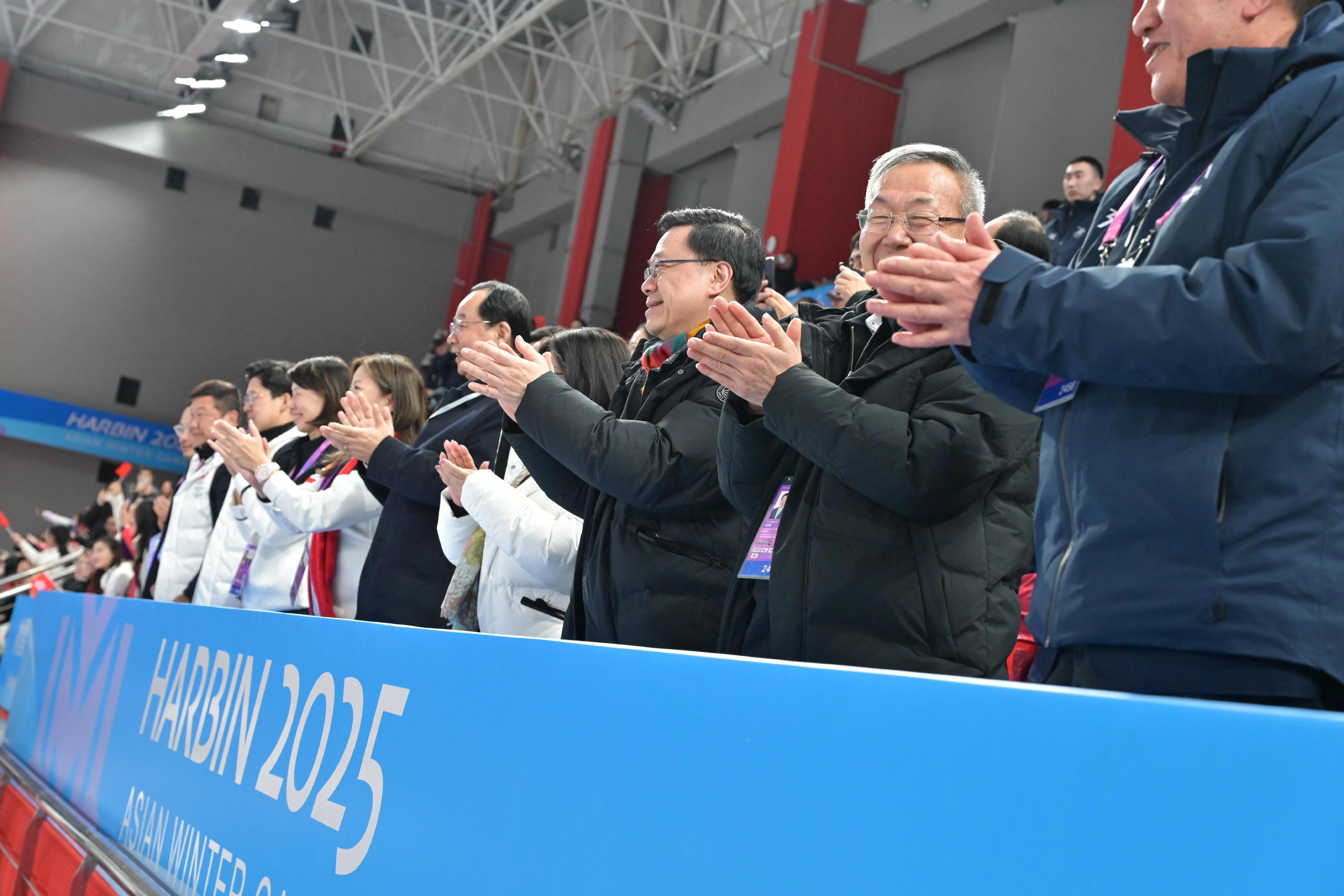 The Chief Executive, Mr John Lee, continued his visit programme in Harbin today (February 8). Photo shows Mr Lee (third right) watching a women's ice hockey competition at the 9th Asian Winter Games Harbin 2025 and cheering for Hong Kong athletes.
