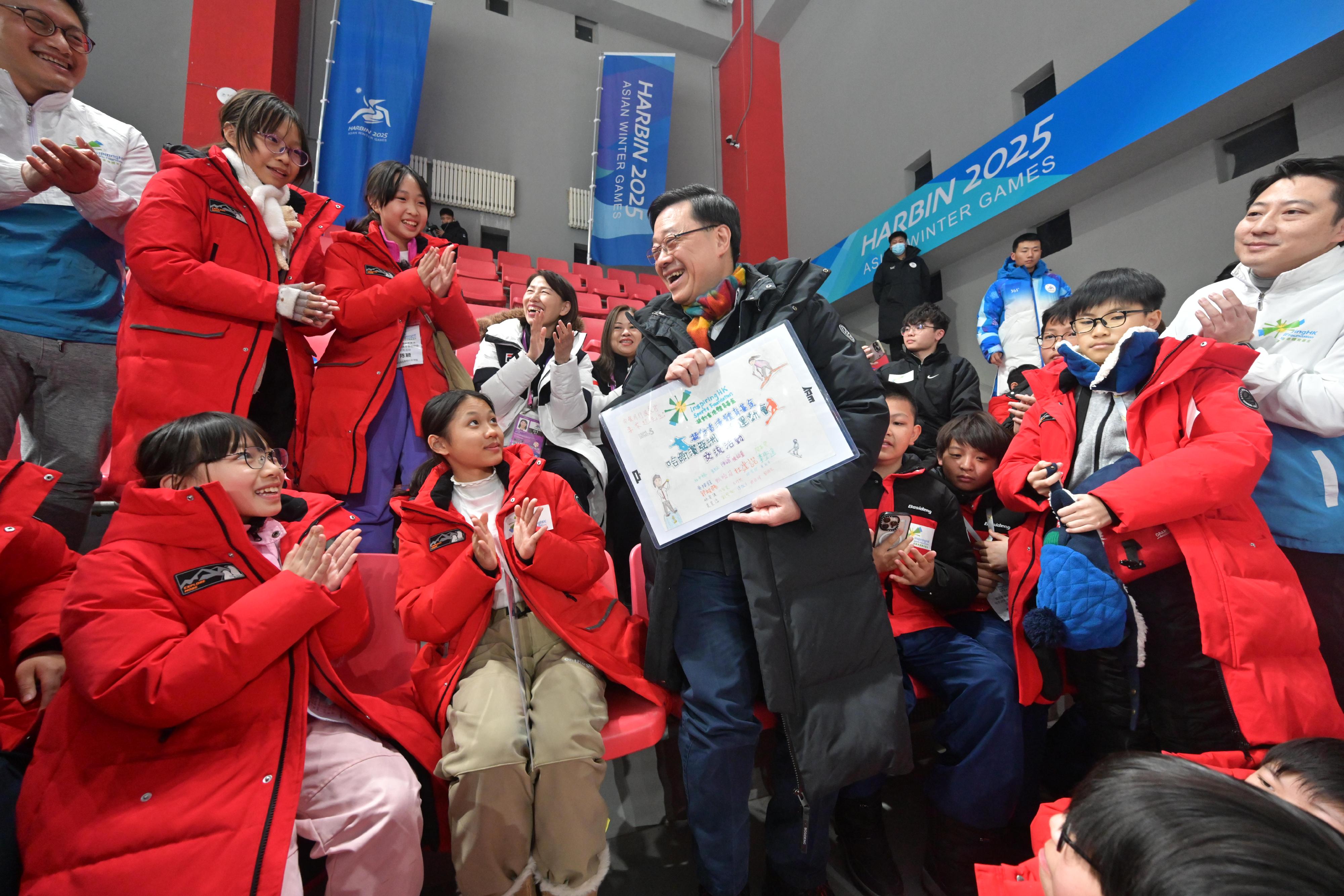 The Chief Executive, Mr John Lee, continued his visit programme in Harbin today (February 8). Photo shows Mr Lee (first row, third left) meeting with Hong Kong young people participating in an exchange programme of the 9th Asian Winter Games Harbin 2025 organised by InspiringHK Sports Foundation.