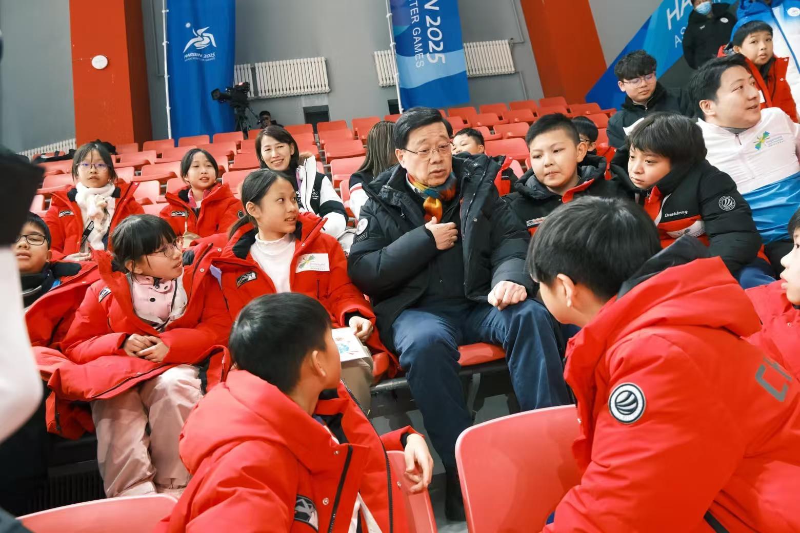 The Chief Executive, Mr John Lee, continued his visit programme in Harbin today (February 8). Photo shows Mr Lee (second row, third left) meeting with Hong Kong young people participating in an exchange programme of the 9th Asian Winter Games Harbin 2025 organised by InspiringHK Sports Foundation.