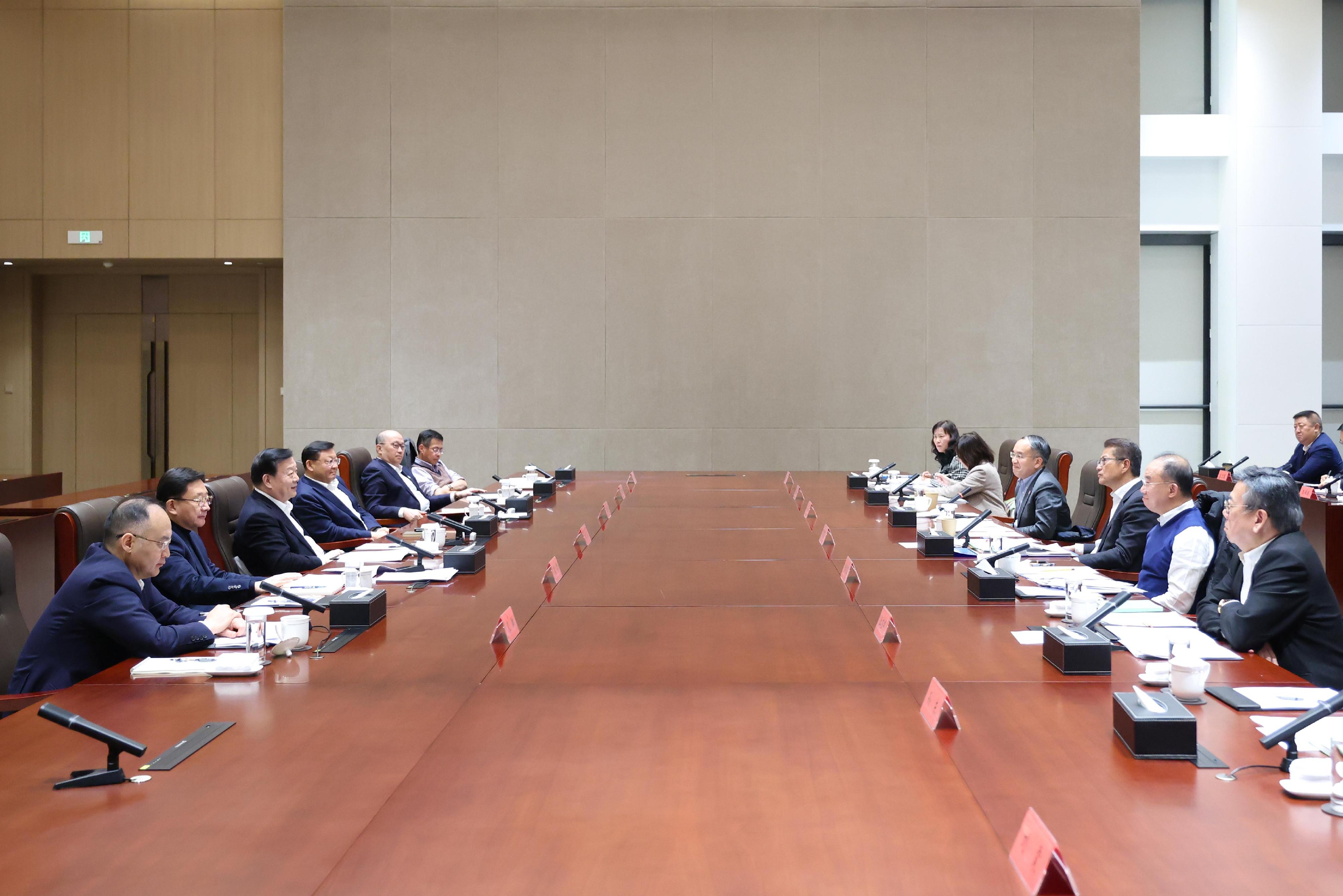 The Director of the Hong Kong and Macao Work Office of the CPC Central Committee and the HKMAO of the State Council, Mr Xia Baolong (3rd left), inspected the Qianhai Shenzhen-Hong Kong Modern Service Industry Co-operation Zone yesterday (February 9). He also hosted a discussion session in which the Financial Secretary, Mr Paul Chan (3rd right), introduced work and focus by the HKSAR Government in 2025 to advance the economy. The Governor of Guangdong Province and Deputy Head of the Office of the Leading Group on Construction of the GBA of Guangdong Province, Mr Wang Weizhong (4th left); Executive Deputy Director of the Hong Kong and Macao Work Office of the CPC Central Committee and the HKMAO of the State Council, Mr Zhou Ji (2nd left); Deputy Director of the Hong Kong and Macao Work Office of the CPC Central Committee and Director of the LOCPG, Mr Zheng Yanxiong (5th left); Deputy Director of the Hong Kong and Macao Work Office of the CPC Central Committee and the HKMAO of the State Council, Mr Nong Rong (1st left); Deputy Director of the LOCPG Mr Qi Bin (6th left); the Secretary for Constitutional and Mainland Affairs, Mr Erick Tsang Kwok-wai (2nd right); the Secretary for Financial Services and the Treasury, Mr Christopher Hui (4th right); the Secretary for Commerce and Economic Development, Mr Algernon Yau (1st right); the Secretary for Development, Ms Bernadette Linn (5th right); and the Secretary for Transport and Logistics, Ms Mable Chan (6th right), also attended.