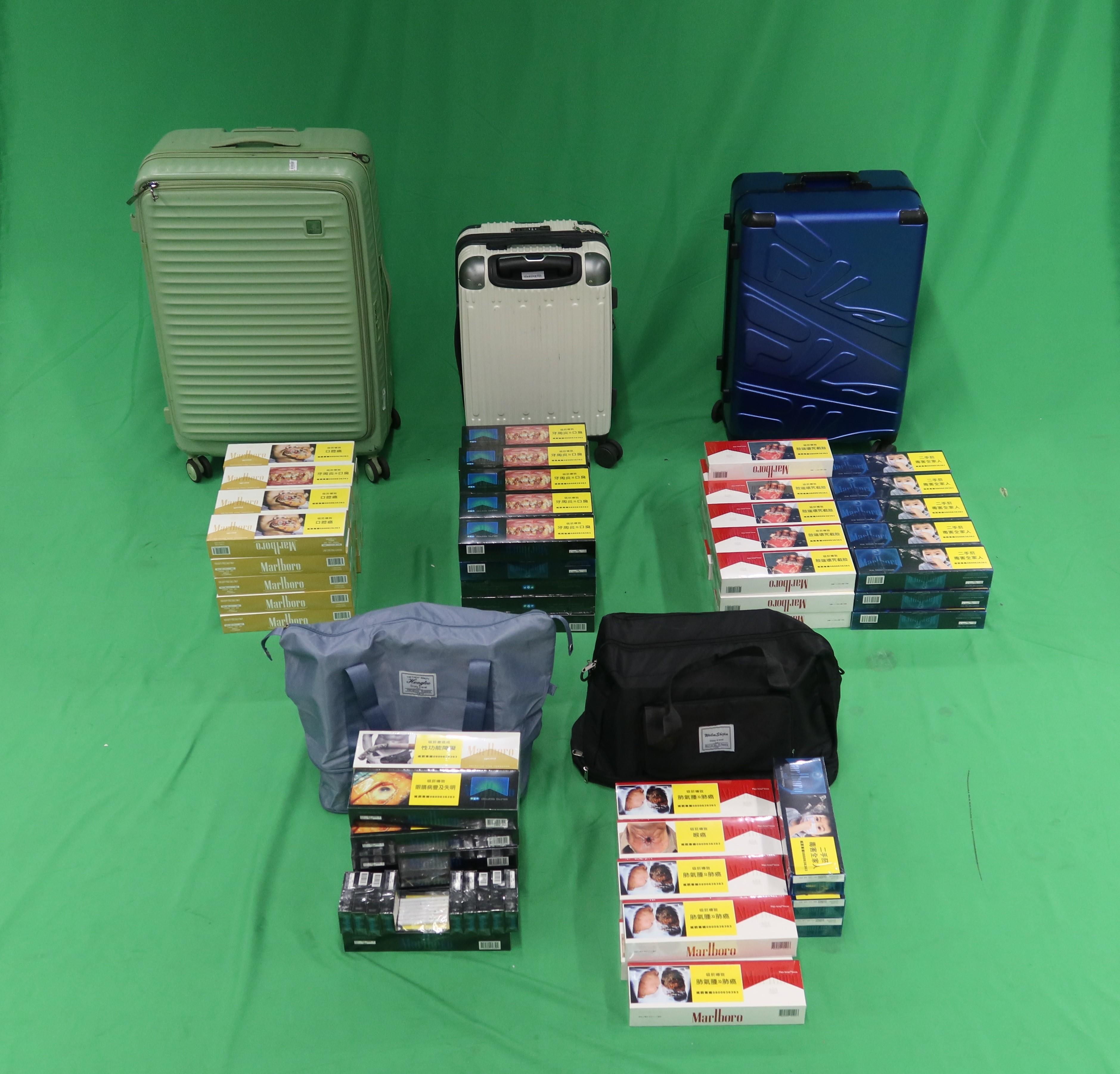 Two incoming male passengers were sentenced to four months' imprisonment, and three months' imprisonment with a fine, respectively, at the West Kowloon Magistrates' Courts today (February 11) for dealing with and possessing duty-not-paid cigarettes, and for failing to declare to Customs Officers, in contravention of the Dutiable Commodities Ordinance. Photo shows the duty-not-paid cigarettes seized. 