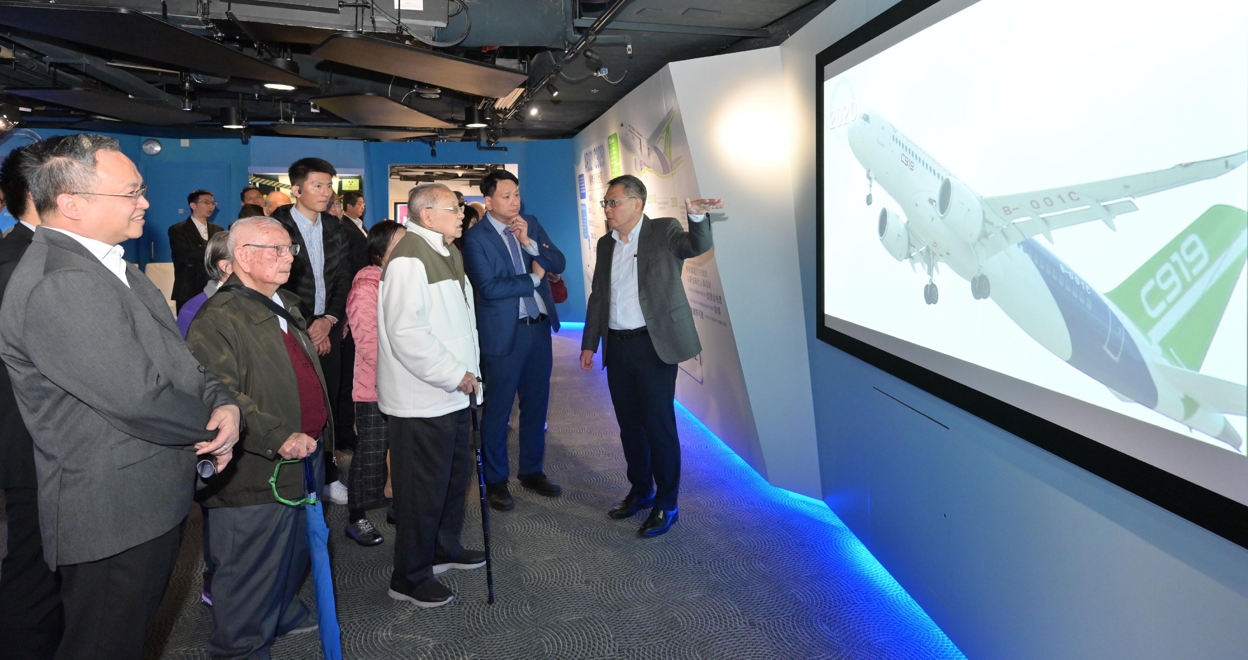 The exhibition galleries on the "Uprising of the Two Airlines" and the civil aviation development of China at the Aviation Education Path, which has been newly set up by the Civil Aviation Department, are open to the public starting from today (February 19). Photo shows visitors viewing information on the building of home-developed aircraft C909 and C919.