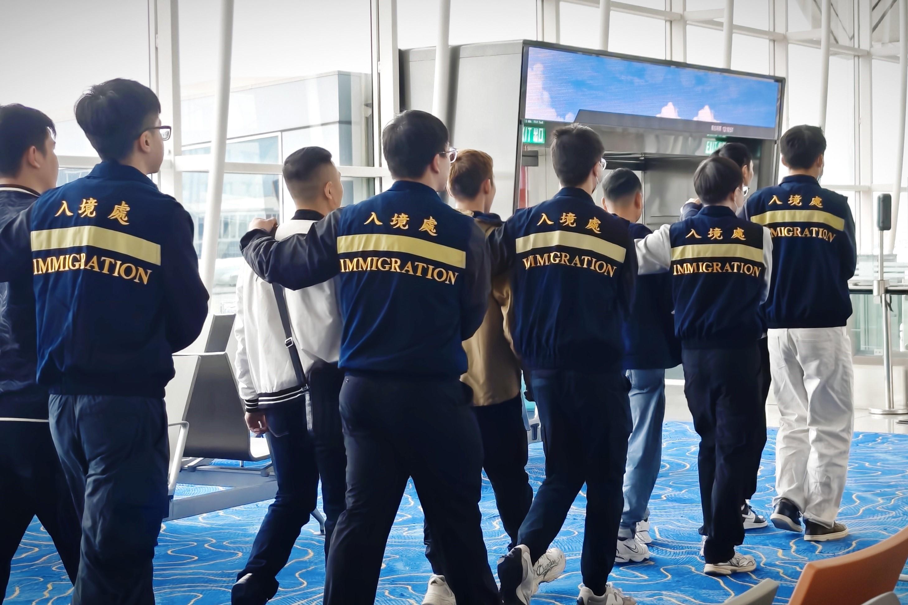 The Immigration Department (ImmD) carried out a repatriation operation today (February 19). A total of 25 Vietnamese illegal immigrants were repatriated to Vietnam. Photo shows removees being escorted by ImmD officers to depart from Hong Kong.