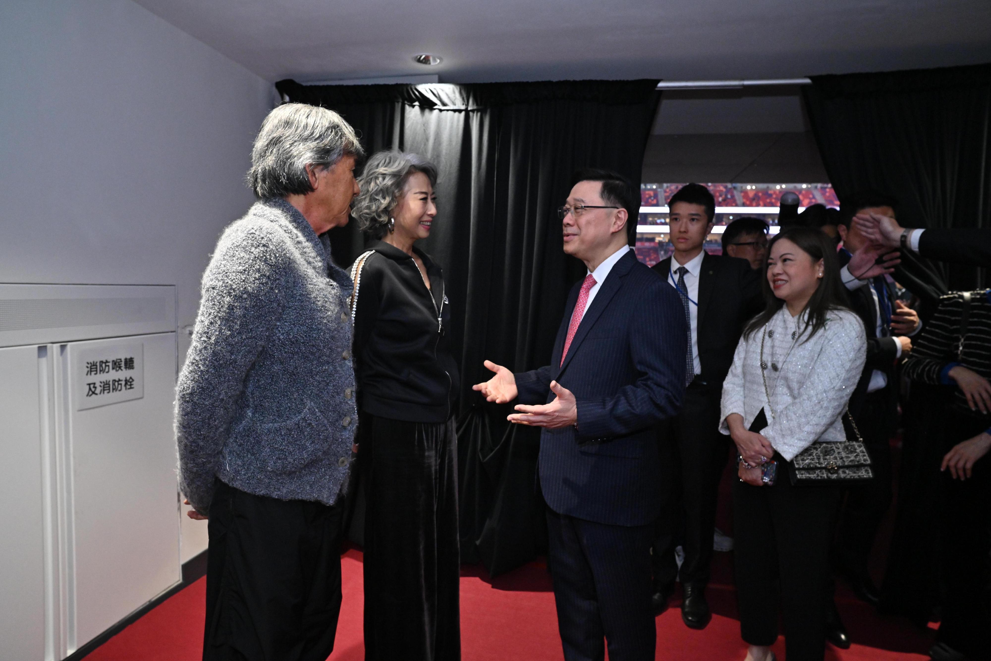 The Chief Executive, Mr John Lee, attended the Kai Tak Sports Park (KTSP) Grand Opening Ceremony today (March 1). Photo shows Mr Lee (third left) interacting with the performing artists at KTSP. Looking on is the Secretary for Culture, Sports and Tourism, Miss Rosanna Law (first right).
