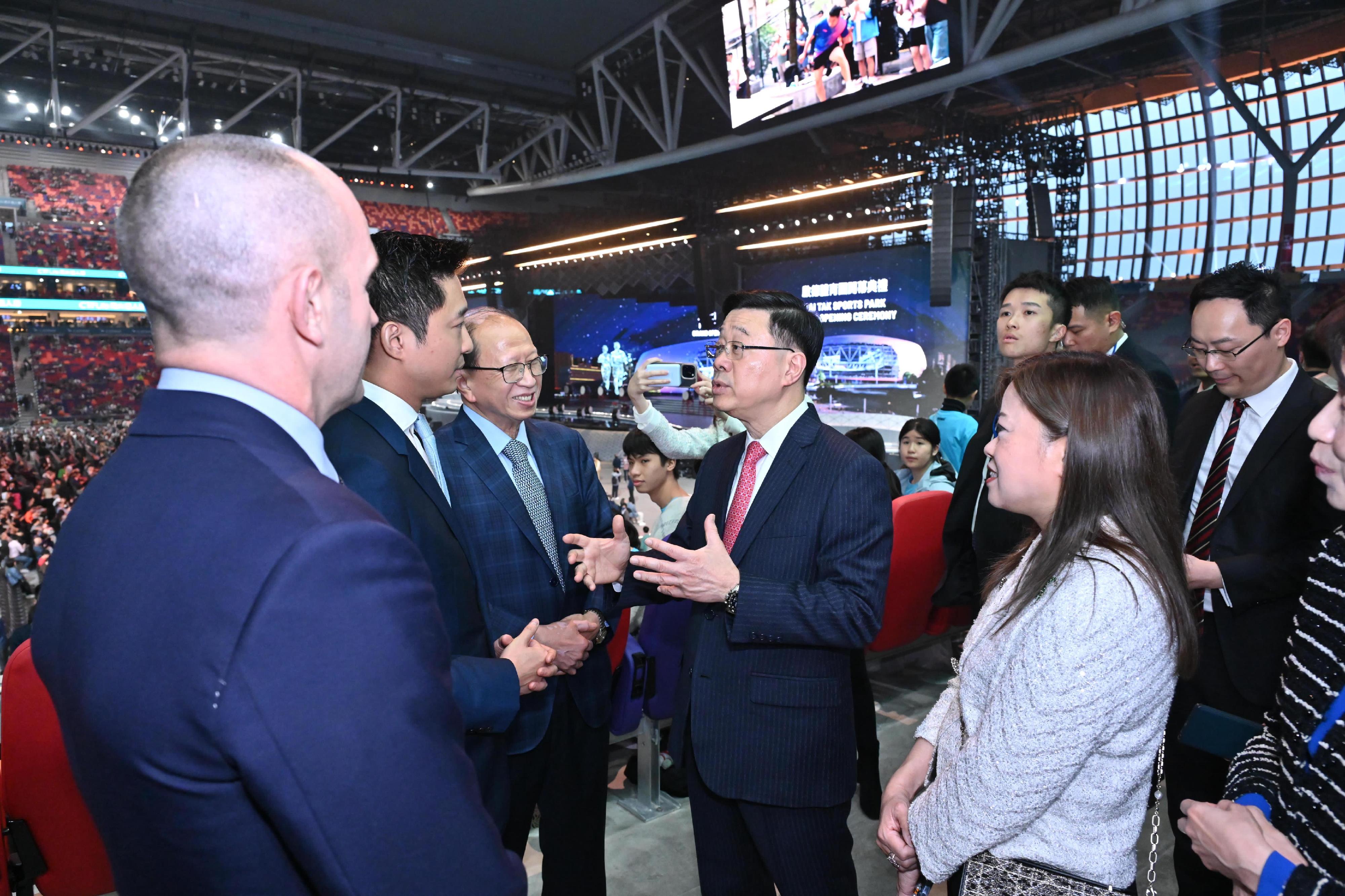 The Chief Executive, Mr John Lee, attended the Kai Tak Sports Park (KTSP) Grand Opening Ceremony today (March 1). Photo shows Mr Lee (second right) interacting with guests at KTSP. Looking on is the Secretary for Culture, Sports and Tourism, Miss Rosanna Law (first right).