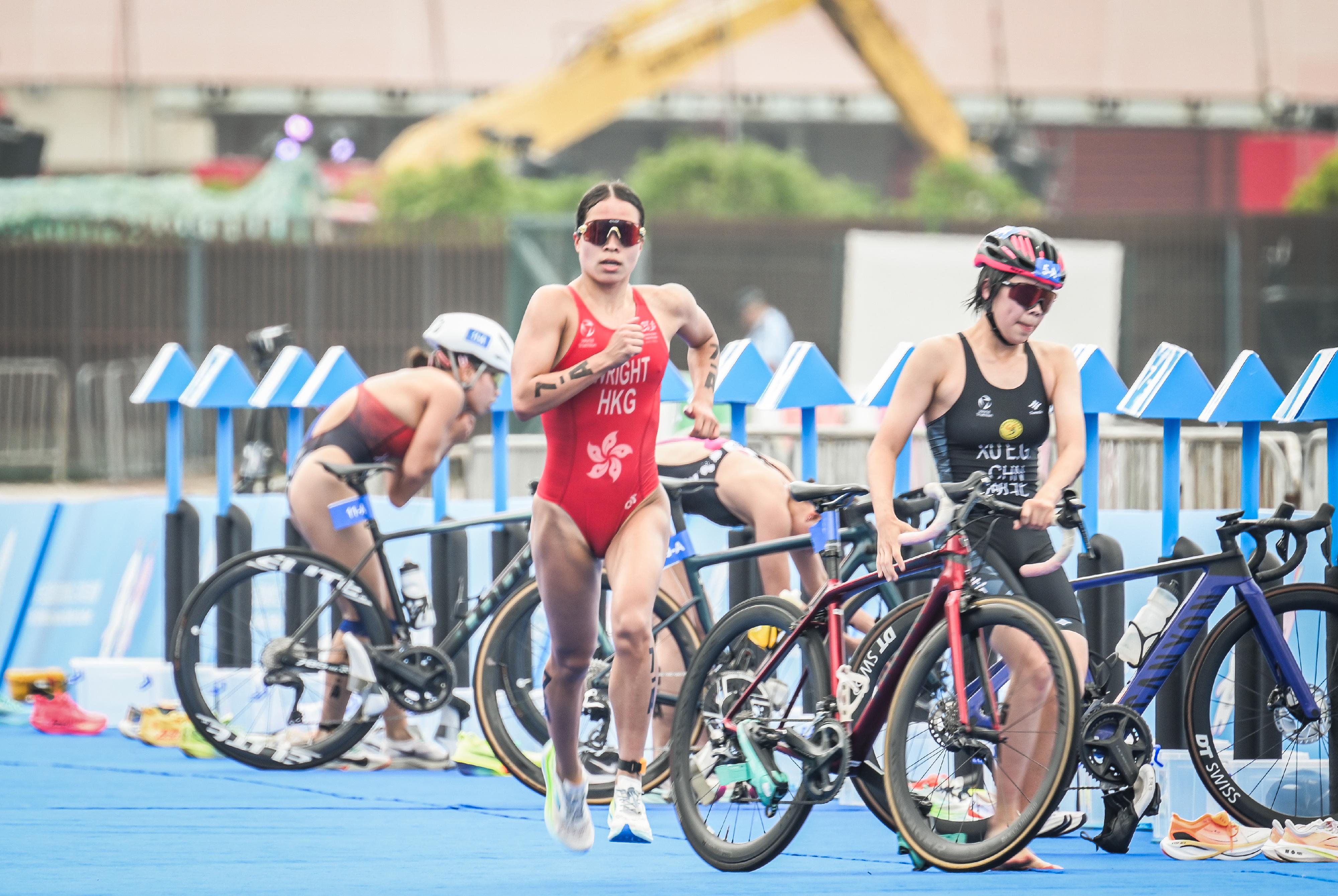 The 15th National Games Triathlon test event was held at the Central Harbourfront and Victoria Harbour today (March 2). Photo shows athletes switching from cycling to running at the transition area.