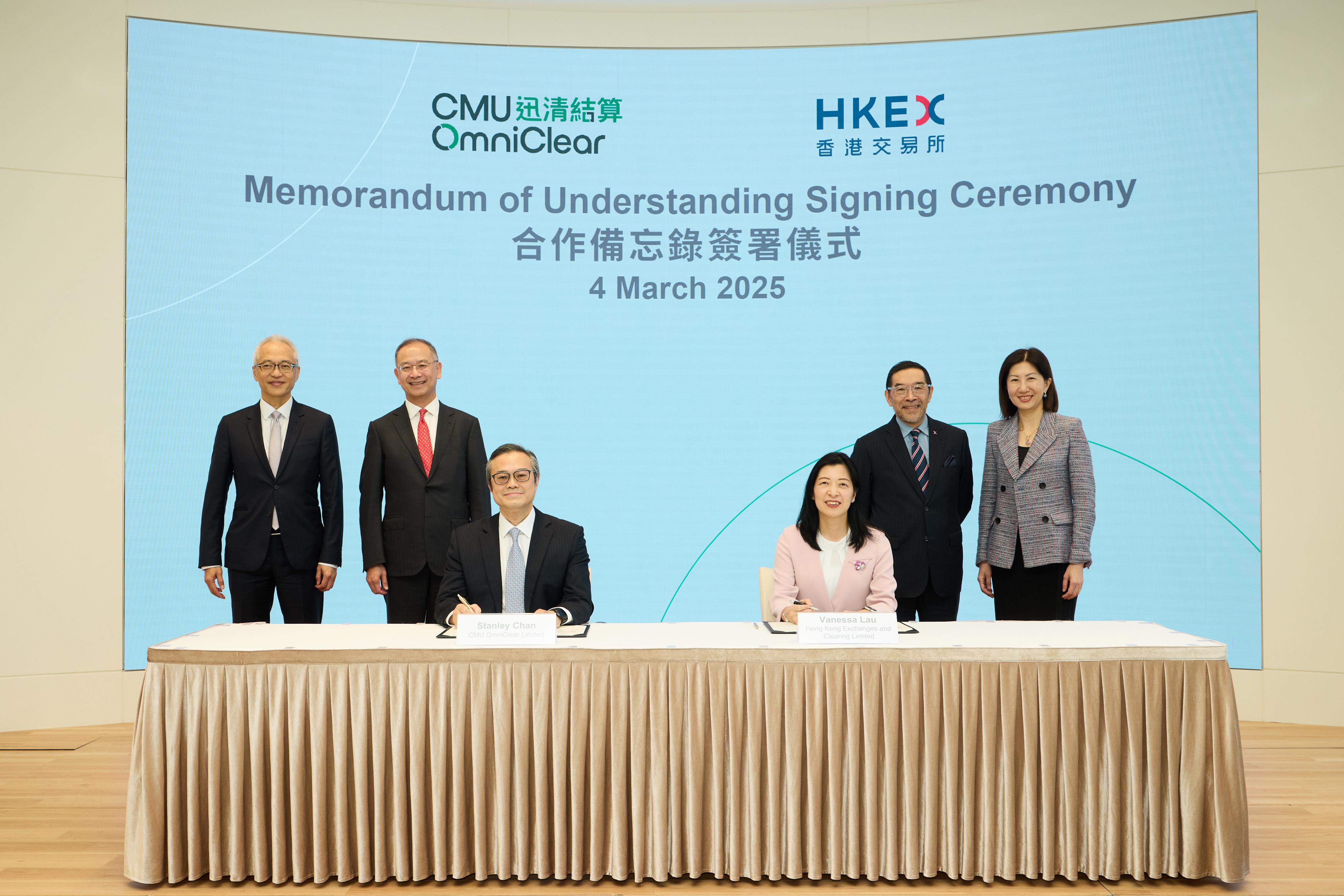 CMU OmniClear Limited (CMU OmniClear), a wholly-owned subsidiary of the Exchange Fund, and Hong Kong Exchanges and Clearing Limited (HKEX) signed a Memorandum of Understanding (MOU) today (March 4). Photo shows the Chief Executive of the Hong Kong Monetary Authority (HKMA) and Chairperson of the Board of Directors of CMU OmniClear, Mr Eddie Yue (back row, second left); Deputy Chief Executive of the HKMA and Deputy Chairperson of the Board of Directors of CMU OmniClear Mr Howard Lee (back row, first left); the Chairman of HKEX, Mr Carlson Tong (back row, second right); and the Chief Executive Officer of HKEX, Ms Bonnie Chan (back row, first right), witnessing the Chief Executive Officer of CMU OmniClear, Mr Stanley Chan (front row, left), and the Chief Operating Officer and Group Chief Financial Officer of HKEX, Ms Vanessa Lau (front row, right), signing a MOU.