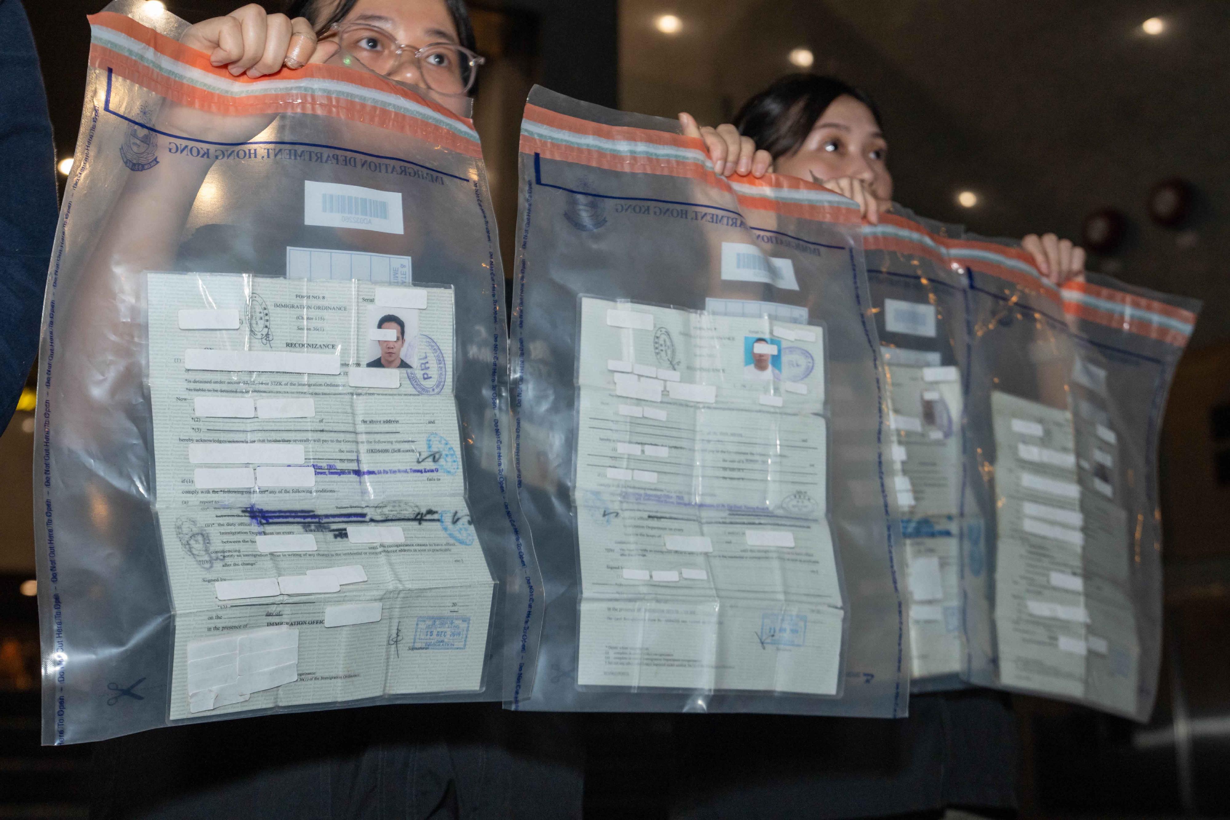 The Immigration Department mounted an anti-illegal worker operation in Kwai Chung on March 4. A total of eight suspected illegal workers and one suspected employer were arrested. Photo shows the recognisance forms, which were held by the suspected illegal workers. 