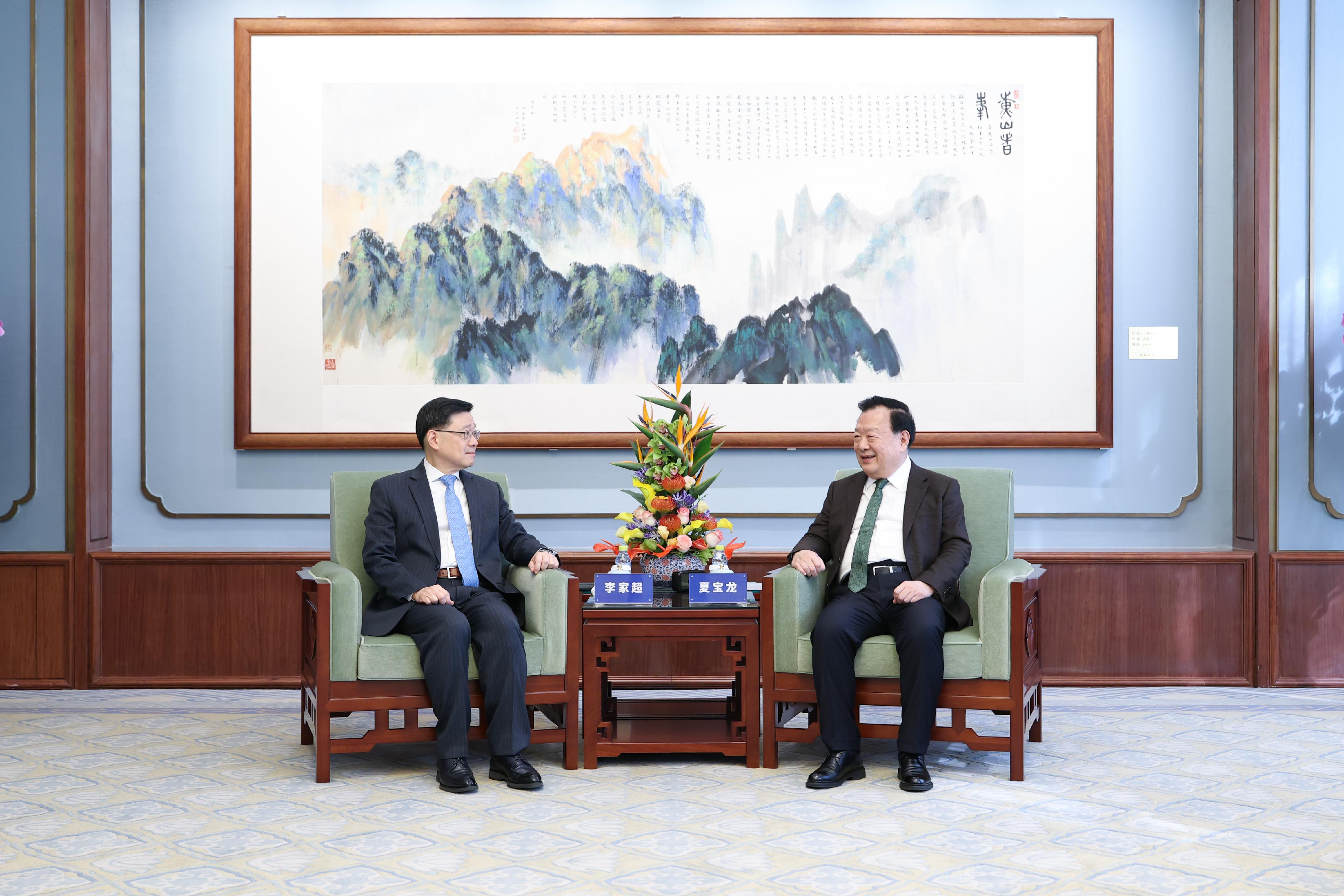 The Director of the Hong Kong and Macao Work Office of the Communist Party of China Central Committee and the Hong Kong and Macao Affairs Office of the State Council, Mr Xia Baolong (right), meets the Chief Executive, Mr John Lee (left), in Beijing today (March 5).