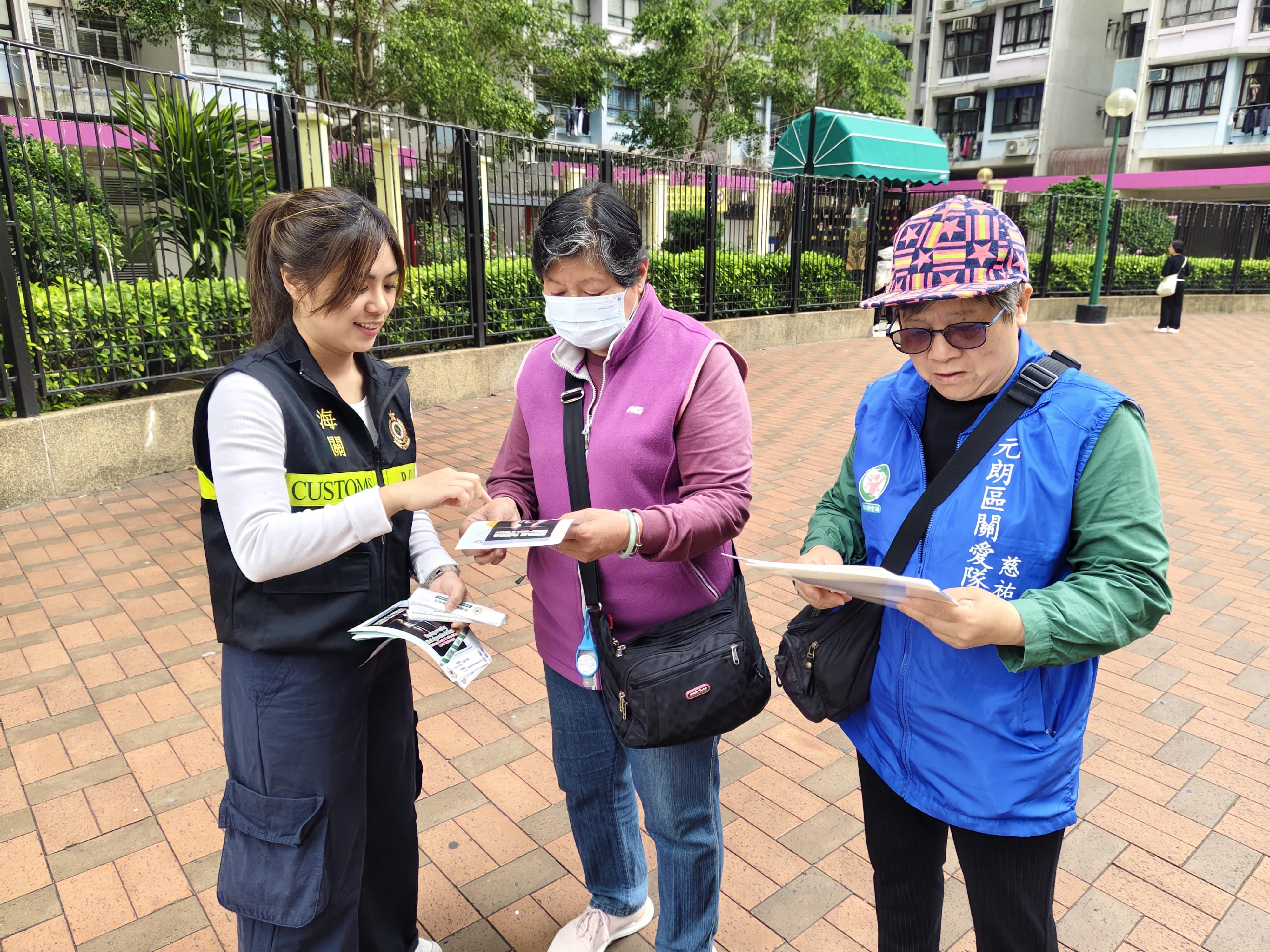 香港海關今日（三月十一日）與多名元朗區區議員和多個政府部門進行聯合反私煙宣傳活動。圖示海關人員及社區關愛隊成員向居民派發宣傳單張。